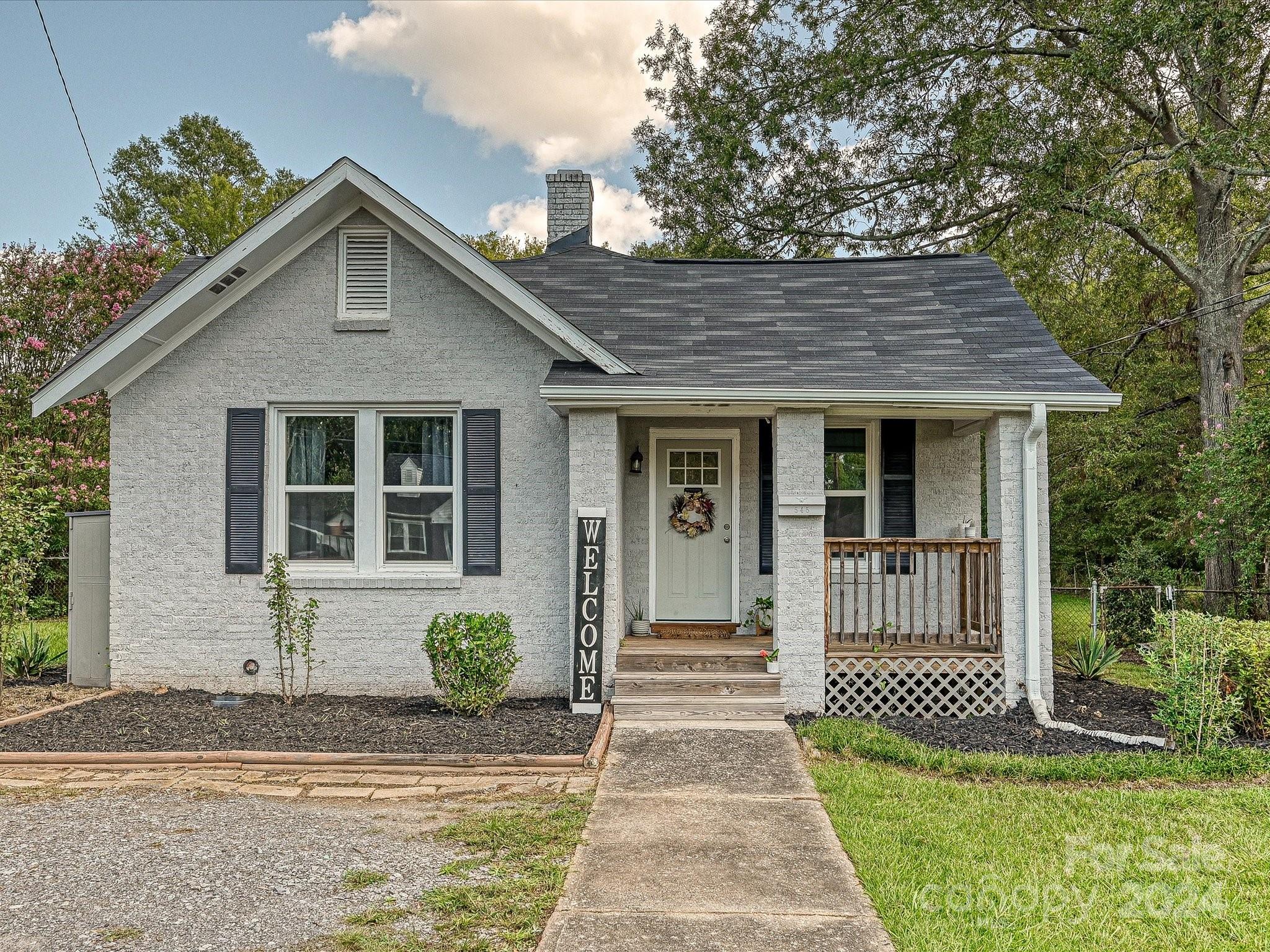 Beautiful two bedroom/two bath brick ranch on a great lot! The previous owners renovated the home;  the open floor plan, kitchen with gas range and hood, and unique light fixtures will please you from the moment you walk in the door. The back yard is perfect for entertaining, with mature trees surrounding for privacy.  Within a mile from downtown Rock Hill and Fountain Park, the location is ideal.  Due to the recent storms, the home has a brand new roof.  There is a termite bond on the property.  You won't be disappointed when you see this one!