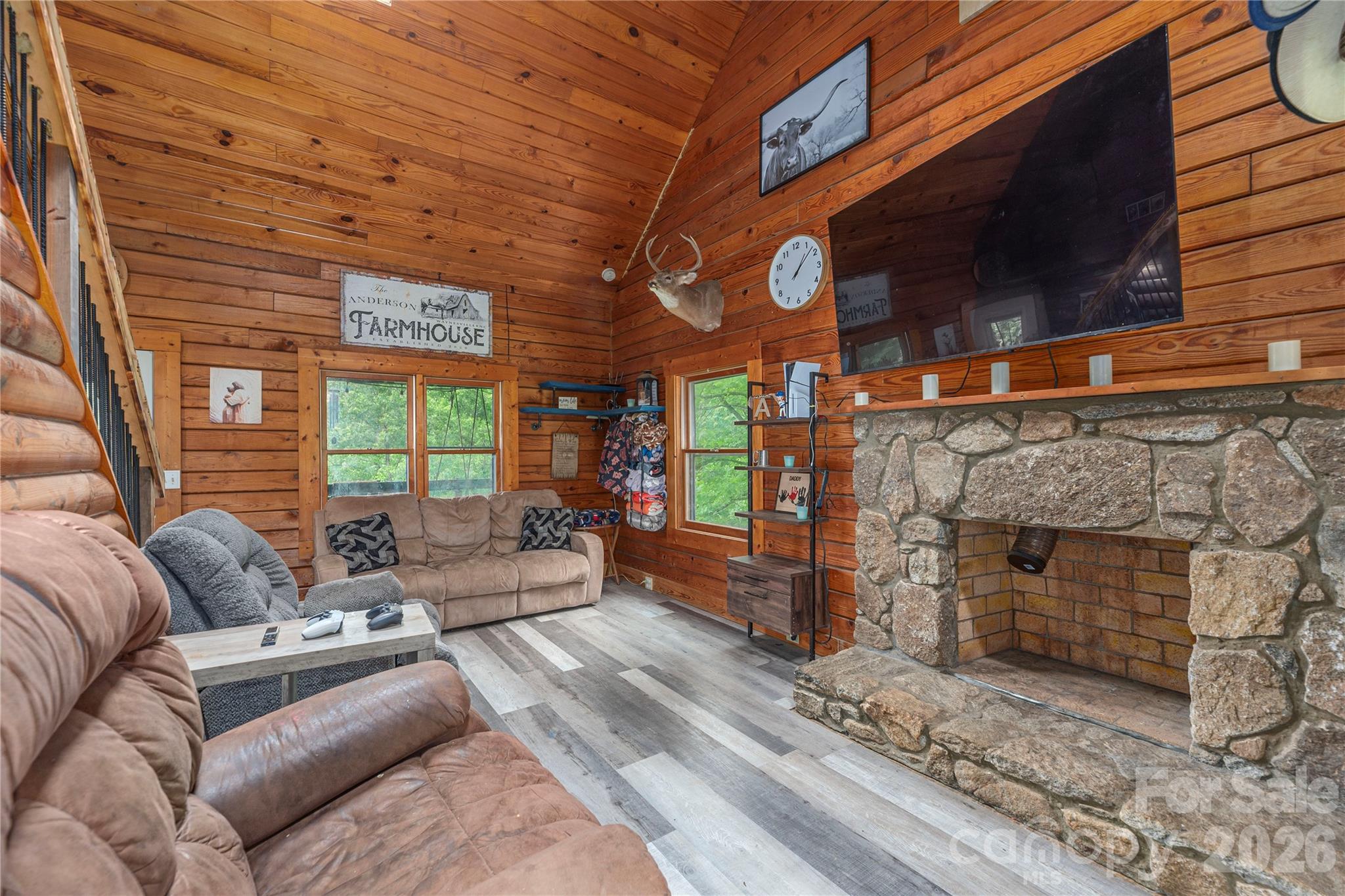 Welcome home to your own slice of Western North Carolina paradise. Nestled on 10.63 unrestricted acres, this authentic log home offers the perfect blend of mountain charm, privacy, and country living. Whether you're dreaming of a horse property, mini-farm, family retreat, hunting getaway, or simply a place to escape the hustle and bustle, this property offers the freedom and space to make it your own. Built in 1984, the 1.5-story home features 3 bedrooms, 2 bathrooms, and 1,924 square feet of warm, inviting living space filled with rustic character. Step inside to discover soaring ceilings, exposed beams, rich wood finishes, and a stunning floor-to-ceiling stone fireplace that serves as the heart of the home. The open-concept living, dining, and kitchen areas create an ideal setting for gathering with family and friends, while large windows bring the beauty of the outdoors inside. The spacious kitchen offers butcher block countertops, stainless steel appliances, abundant cabinetry, and a large island perfect for meal preparation, entertaining, or casual dining. Upstairs, a loft overlooks the great room below and provides flexible space for a home office, recreation room, play area, reading nook, or additional living space. Outside is where this property truly shines. Horse lovers will appreciate the 3-stall horse barn and acreage that provides room for riding, grazing, and enjoying the equestrian lifestyle. The unrestricted land opens the door to countless possibilities, whether you're interested in farming, gardening, raising animals, recreational use, or simply enjoying the peace and privacy of your own mountain retreat. Adding to the property's natural beauty, a creek meanders along the lower boundary, creating a peaceful setting where you can relax to the sound of flowing water and enjoy the sights and sounds of nature. Spend your days exploring your own acreage, watching wildlife, riding horses, gardening, or gathering around a fire under the stars. The unfinished basement provides extensive storage, workshop space, and room for future expansion. Whether you need space for tools, equipment, outdoor gear, hobbies, or envision additional finished square footage in the future, the possibilities are endless. Properties offering unrestricted acreage, a horse barn, creek frontage, and the timeless appeal of a true log home are becoming increasingly difficult to find. This unique mountain property combines rustic charm, functionality, privacy, and natural beauty into one exceptional opportunity. Bring the horses, bring the chickens, plant the garden, cast a line in the creek, and enjoy the freedom that comes with 10.63 unrestricted acres in the mountains of Western North Carolina.