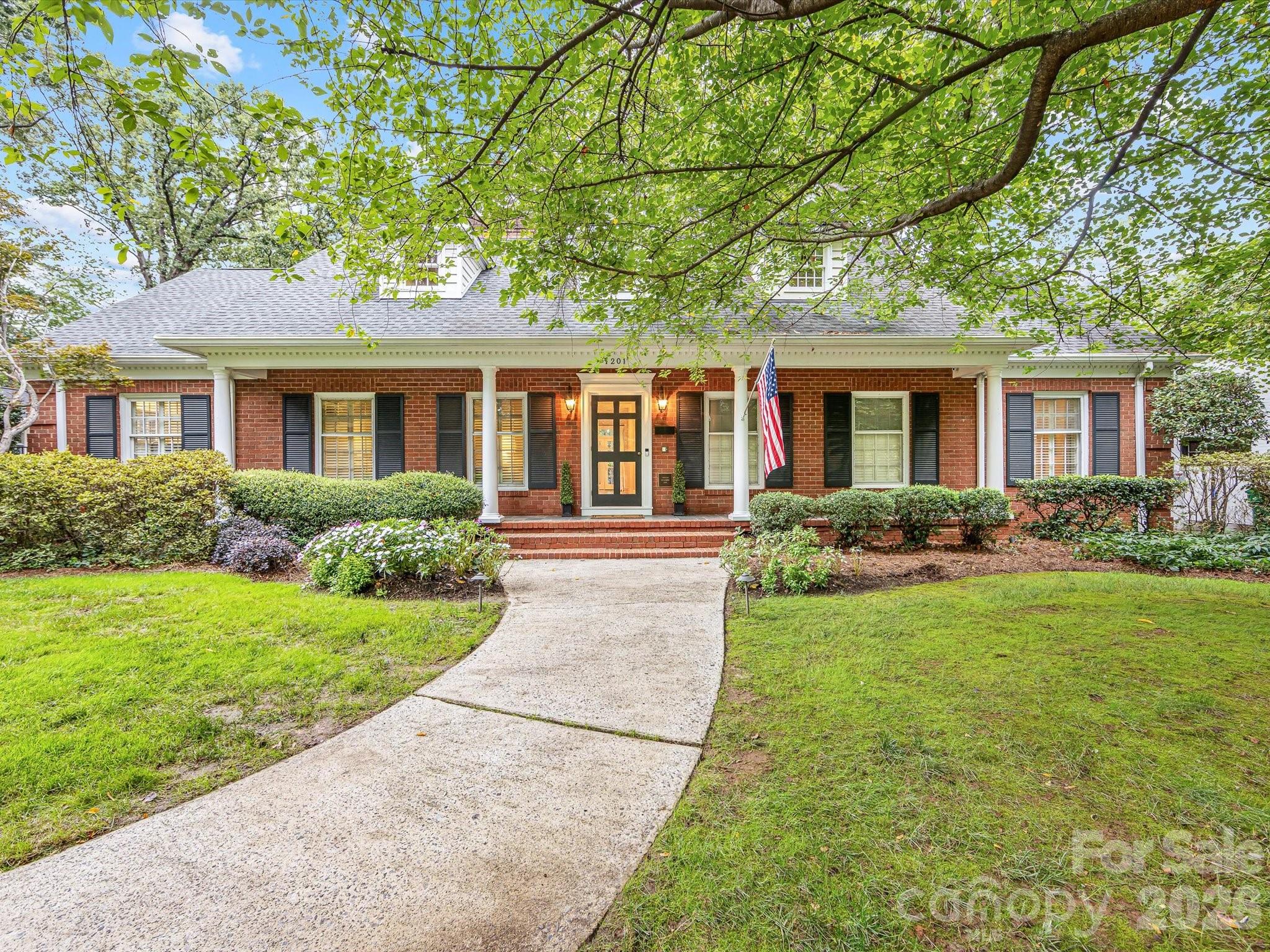 Nestled in the heart of Dilworth on an oversized lot, 1201 Belgrave offers rare space and luxury in one of Charlotte’s most sought-after neighborhoods. This fully renovated home features 5 bedrooms and 3.5 baths, including a primary suite on the main level with dual closets and a versatile office or sitting room. Upstairs you'll find two bedrooms adjoined with an updated full bath and a spacious bonus room, plus dedicated office. The gorgeous chef’s kitchen boasts a wolf range, ss appliances, a large marble island and generous dining area. The kitchen opens into the incredible light-filled family room that boasts built-ins flanking the fireplace and a wall of windows and french doors leading out back. Side entry provides drop-zone with mudroom and large laundry room with ample storage. Detached two-car garage includes a sixth bedroom above with kitchenette and full bath, ideal for guests. Outdoor living is unmatched with an oversized covered porch and fireplace, built-in outdoor kitchen, turfed backyard, and sport court. Fully fenced with electric gate. Fabulous location near Latta Park, convenient to Uptown and all that Dilworth has to offer!