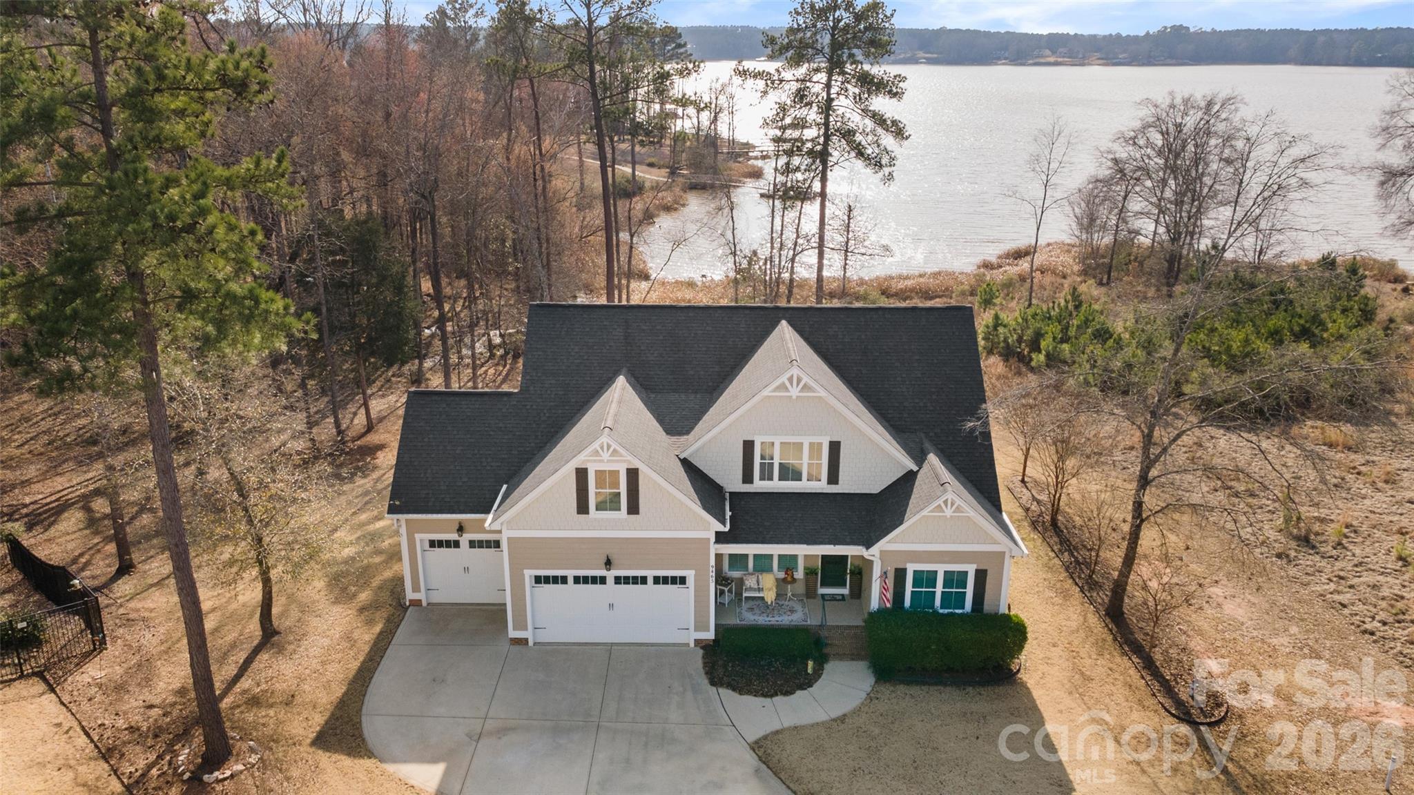 Gorgeous WATERFRONT two-story home in the Edgewater golf community, offering beautiful water views and thoughtfully designed living spaces throughout! Gleaming wood floors welcome you into the elegant dining room complete with a stylish chandelier and classic board and batten detailing. The open-concept living room showcases a gas log fireplace with mantel, coffered ceiling with recessed lighting, and a dramatic wall of windows which provide  sweeping water views and filling the home with natural light.

The kitchen is a true centerpiece, anchored by an oversized island with seating and featuring a gas range with hood, tile backsplash, stainless steel appliances, ample cabinetry, weathered Quartz countertops and a sunny breakfast nook overlooking the water - perfect for morning coffee with a view.

Privately situated at the back of the home, the primary suite offers a tray ceiling and a spa-like ensuite bath with dual sink vanities, an oversized tiled shower with glass door, and a spacious walk-in closet. A generous guest bedroom sits at the front of the home with access to a full hall bath, making it ideal for visitors or a home office.

Upstairs, a versatile bonus room opens to a large guest space/playroom, providing endless possibilities for entertaining, hobbies, or additional storage. Two additional secondary bedrooms share a full hall bath, offering comfort and flexibility for family or guests. 

Step outside to enjoy warm Carolina spring days on the screened-in porch with ceiling fan, or gather around the custom fire pit along the charming paver pathway. Additional highlights include a true laundry room with built-in cabinetry and countertop workspace, and a three-car garage for added convenience and storage. *One note, this lot does not allow for a dock, but a slip can be rented at the Marina within the community. Additional features include a welcoming front porch, 3 car garage and private cul-de-sac street.

This resort style community features a public golf course & Marina with boat storage. Amenities include a brand new Clubhouse with restaurant & bar, outdoor swimming pools, tennis courts, pickleball, playground, recreation area, social clubs/entertainment, street lights, sidewalks and walking trails. 

This Edgewater beauty combines stunning views, functional design, and inviting indoor-outdoor living—don’t miss your opportunity to call it home!
