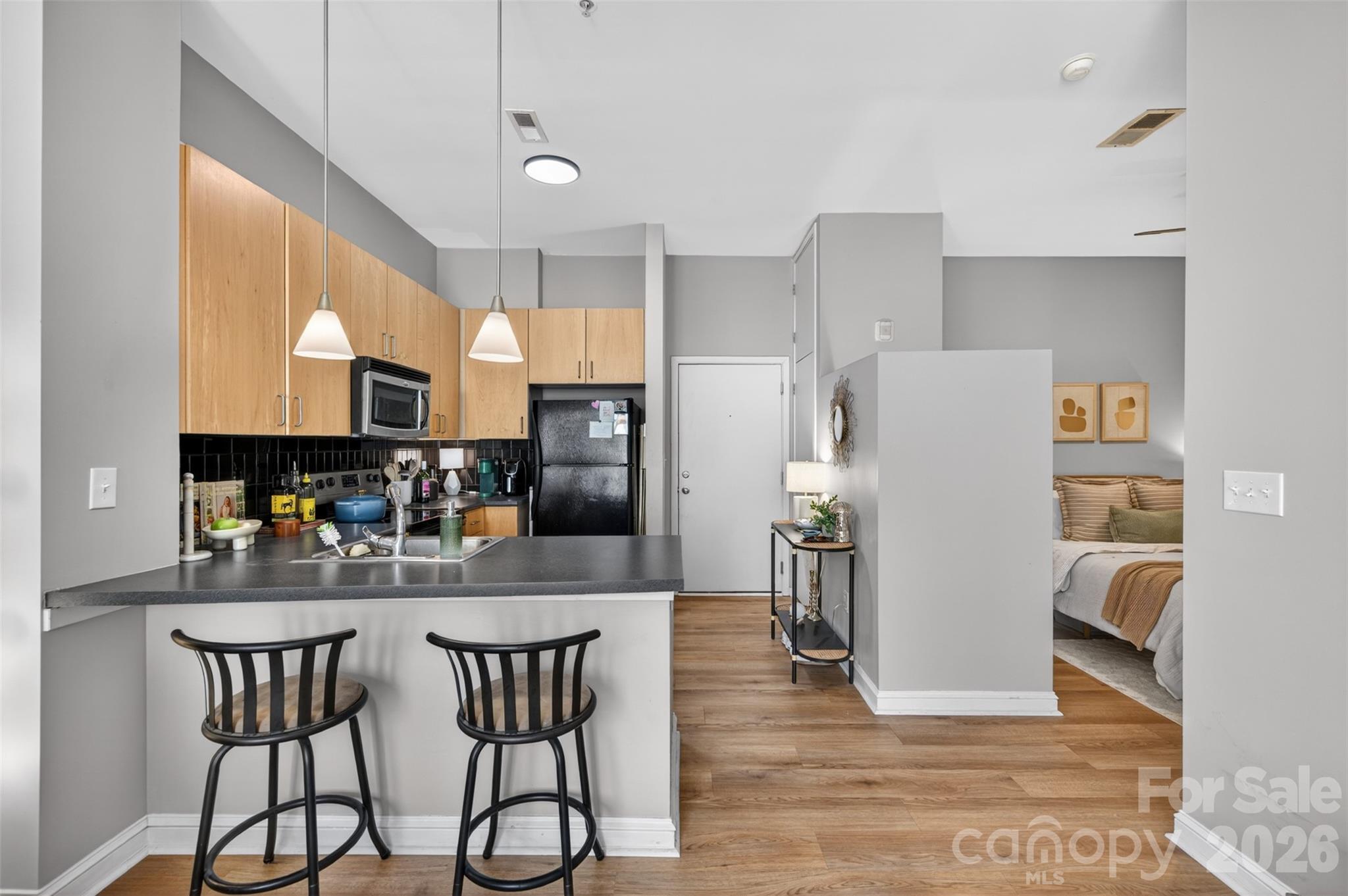 MOVE-IN READY studio condo in highly desired Southend Village! Take the convenience of the elevator or park in the gated garage to the 3rd floor, and this unit greets you with its airy, OPEN FLOORPLAN! This cute condo SHOWS LARGE, with its kitchen featuring great cabinet space planning and opening right into the cozy, bright living room & dining area w/ an oversized window, filling the condo w/ great natural lighting. Open primary bedroom & full bath w/ tiled walk-in shower & walk-in closet w/ laundry! Unbeatable location that is only a few blocks to Dilworth & Uptown Charlotte. Enjoy this community with access to many restaurants, breweries, coffee shops, and explore shopping options. Easy access to nearby light rail station to explore even more nightlife options! Come tour this beautiful condo before it's gone!