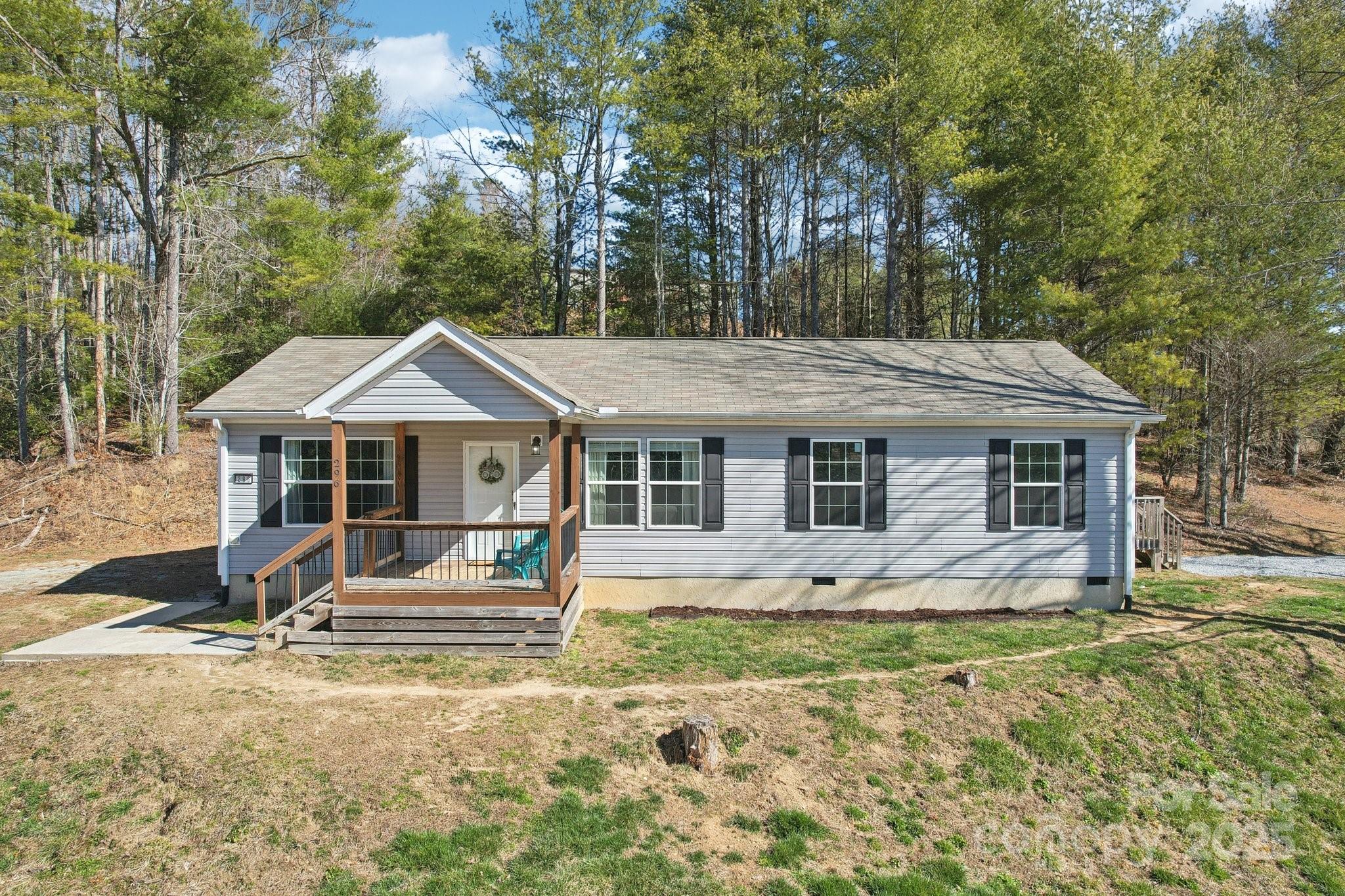 This beautiful 3 bed 2 bath home is tucked away in a quaint neighborhood just around the corner from popular Jeter Mountain Farm and less than 10 miles to both the amenities of downtown Hendersonville and the adventures that abound in Dupont State Recreational Forest! Situated on a 1.41 acre cul-de-sac lot, this property offers 2 driveways, an inviting covered front porch along with side and rear porches, and a great mix of wooded and cleared space to enjoy. The interior of this lovely home offers a desirable split bedroom floor plan, open concept living area flooded with natural light, and easy to maintain one level living. This home would be perfect for buyers who are just starting out their home ownership journey, those looking to downsize, or even buyers looking for a peaceful mountain getaway or investment property to add to their portfolio. Fantastic property at a great value!