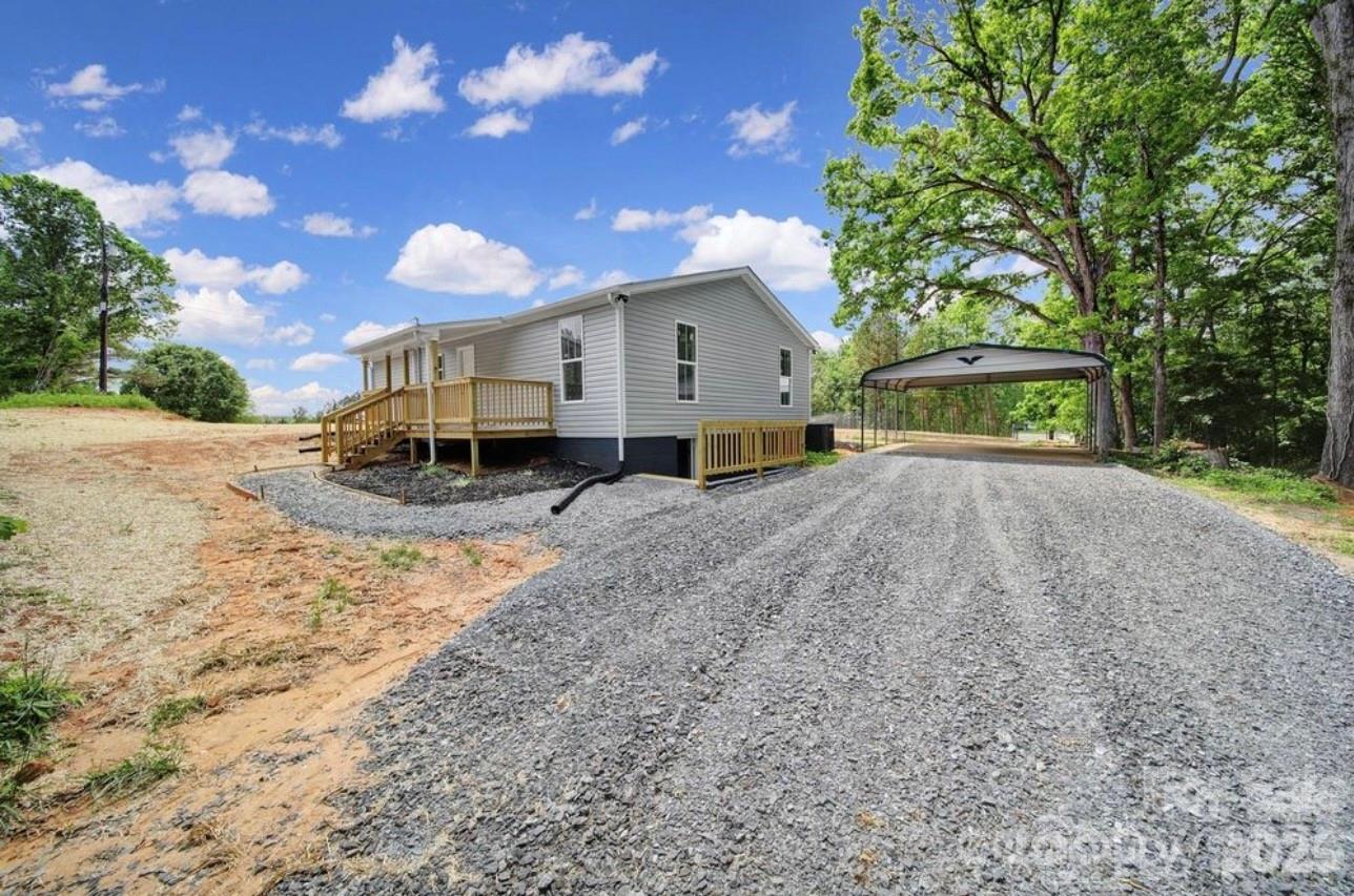 Completely Renovated 3BR/2BA Home on .71 Acres – Move-In Ready! This beautifully renovated 3-bedroom, 2 full-bath home offers 1,272 square feet of stylish, modern living on a private .71-acre lot. Every detail has been thoughtfully updated, giving you the peace of mind that comes with the comfort of a truly move-in-ready home.
The primary suite features a private ensuite bath and a walk-in closet, creating the perfect retreat at the end of the day. The inviting living room showcases a striking modern black accent wall with a built-in electric fireplace, adding warmth and contemporary charm to the heart of the home. Extensive renovations include a new roof, HVAC system, plumbing, electrical, siding, and covered front and back porches. A freshly painted 336-square-foot basement provides flexible space ideal for storage, hobbies, a workshop, or additional utility needs. Outside, enjoy the privacy of a tree-lined setting complete with a new gravel driveway and a metal 2-car carport. Whether you're relaxing on the porch, working on projects, or simply enjoying the peaceful surroundings, this property offers the perfect blend of comfort and functionality. Conveniently located just minutes from Hwy 74 and within easy reach of Shelby, Cherryville, and Lincolnton, this fully renovated home combines country tranquility with everyday convenience. Don't miss this exceptional opportunity!