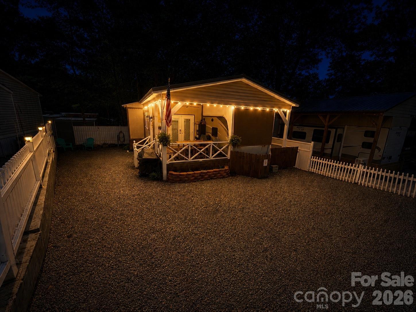 Welcome to this beautifully maintained and well appointed 2016 Keystone Cougar 36' featuring 2 slides-outs and a spacious full addition. Relax and entertain on the covered front porch complete with custom bar, cozy seating area  and a small beverage refrigerator. Step inside to a warm and inviting living space featuring stylish decor, bead board ceiling and wide plank laminate flooring throughout. The couch makes a queen size bed. The open concept layout flows seamlessly from the living room into the kitchen, highlighted by a large center island and ample workspace. The dining area is currently set up a home office and includes a charming fireplace for added comfort.
The bedroom offers a queen size bed, while the oversized bathroom includes a washer and dryer that will remain with the home. Additional insulation has been added to the walls and ceiling for improved efficiency and comfort. Recent updates and improvements include: New GE 18 gallon electric water heater (installed 2/26), Smart Capabilities: WiFi Door lock and thermostat. HVAC fully serviced. Replaced the air handler control board and outside unit defrost board (12/25). Complete PEX Re-plumbing with the camper hot water connection. Fully operational camper HVAC system. Most furnishings and appliances will remain, excluding the safe, green kitchen lamp and bathroom picture. This move in ready property offers comfort, convenience and charm!!  Come and see if this is your "Happy Place" here in the park.

All buyers must be with realtor to gain access to the community.