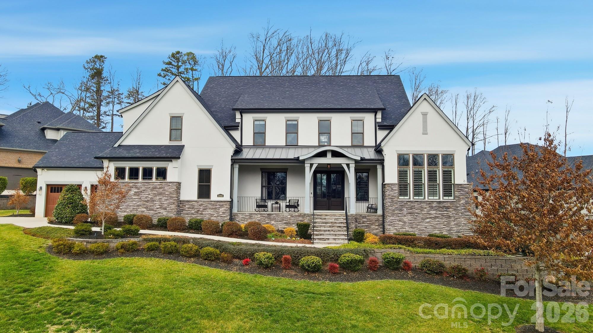 Welcome to this meticulously maintained 4-bedroom, 4.5-bath home nestled in the boutique community The Woodlands of Davidson, where thoughtful design meets everyday luxury.  Custom touches throughout include four car garage, designer wallpaper, extensive crown molding, luxury lighting, solid-core doors, and thoughtfully designed cabinet and drawer inserts that elevate both style and organization.  Designed with an open floor plan and abundant natural light, the heart of the home is the chef’s kitchen, featuring quartz countertops, an oversized island, six burner gas range with griddle, double ovens, pot filler, and a hidden walk-in pantry with secondary refrigerator and extensive shelving.  The kitchen opens seamlessly to the great room, highlighted by a stunning floor-to-ceiling tiled fireplace and fully retractable doors leading to the back porch.  Just off the kitchen, an oversized mudroom adds incredible convenience with washer and dryer, drop zone, and a dedicated dog wash station, leading to the garage.  The main level also offers a formal dining room, a dedicated bar area, and a casual dining space, providing flexibility for everything from intimate dinners to larger gatherings.  The primary suite is a true retreat, complete with his-and-her custom closets and a spa-inspired bath featuring dual vanities and a striking wet room with soaking tub and rain-head shower.  The main floor also includes a private home office with French doors and a guest bedroom with access to a full bath, ideal for visitors or multi-generational living.  Upstairs, you’ll find two additional bedrooms, each with its own full bath.   The recreation room with pool table steps down to a media room with automatic room-darkening blinds perfect for a movie night.  An additional bonus room—perfect for workouts, crafts, play space, or flexible living round out the upper floor.  Outdoor living truly shines with a screened-in porch featuring automatic screens and a gas fireplace, plus a dedicated outdoor dining area with built-in grilling station, creating the perfect setting for relaxing or hosting year-round.  Ideally located with easy access to I-77, top-rated schools, shopping, restaurants, and Downtown Davidson, this home blends luxury and comfort in one of the area’s most sought-after communities.