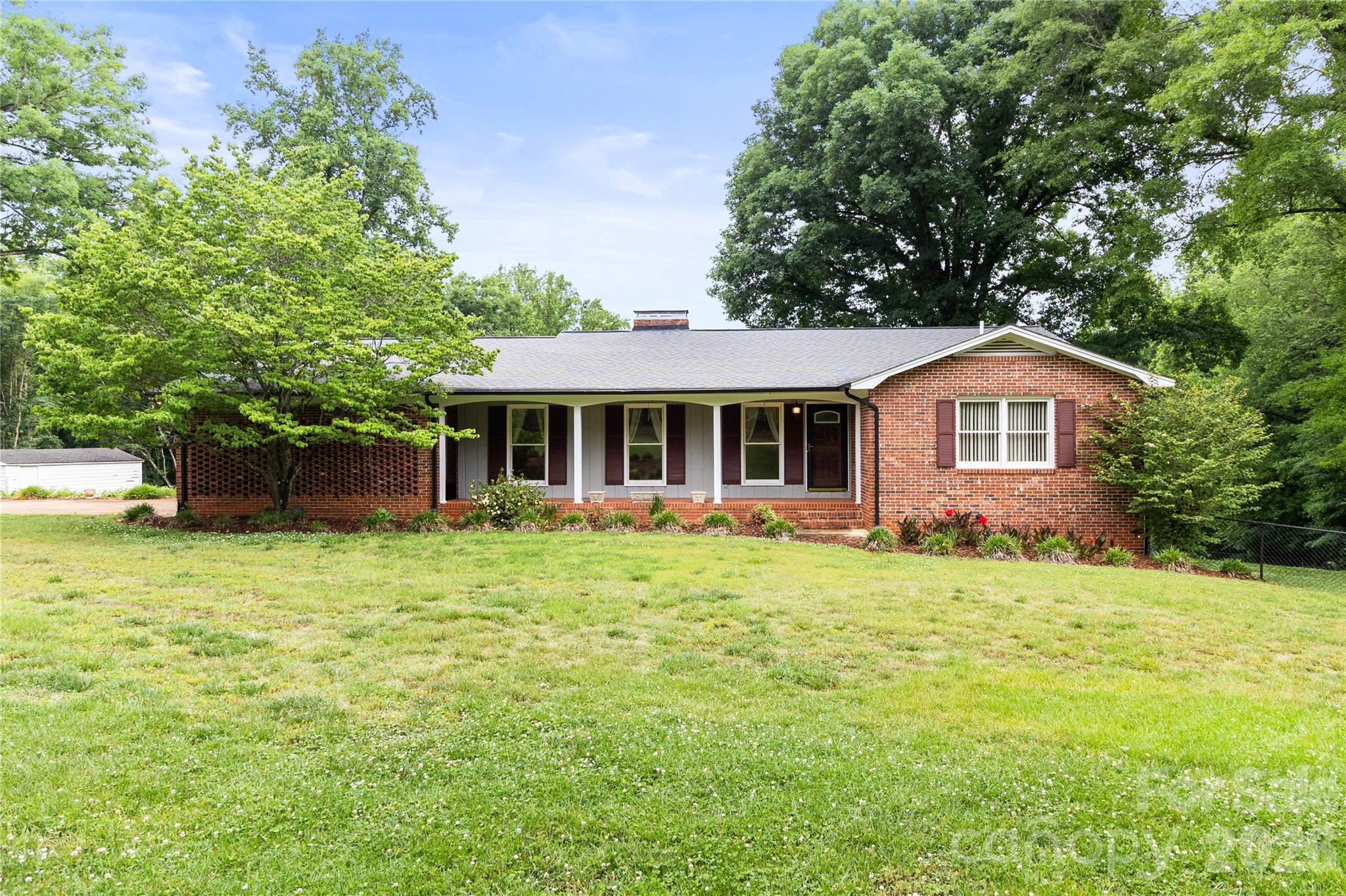 This is a very well maintained three bedroom two bath full brick home situated on three beautiful acres. Located on a peaceful dead end road with very little traffic. The main level includes a comfortable family room and functional kitchen. It includes separate dining room and living room as well. The hall bathroom is well appointed with double sinks and tub/shower combination. Primary bedroom features a private full bath as well as a spacious closet. Full basement is ideal for entertaining complete with cabinetry, woodstove and refrigerator. Pool table in basement will stay. Exterior of the home includes an attached double carport, fenced inground pool with pool house and chicken coop. Entire yard and pool area have immaculately maintained landscaping. Side yard of home is fenced with chain link and is perfect for pets. Large deck on main living area and covered area in rear of home are both ideal for hosting . The three acres with property can easily be a home for horses. House and pool are on county water but there is an existing well on the property that current homeowners have never used. This property is ideal for a buyer wanting quiet country life with plenty of space. A must see!