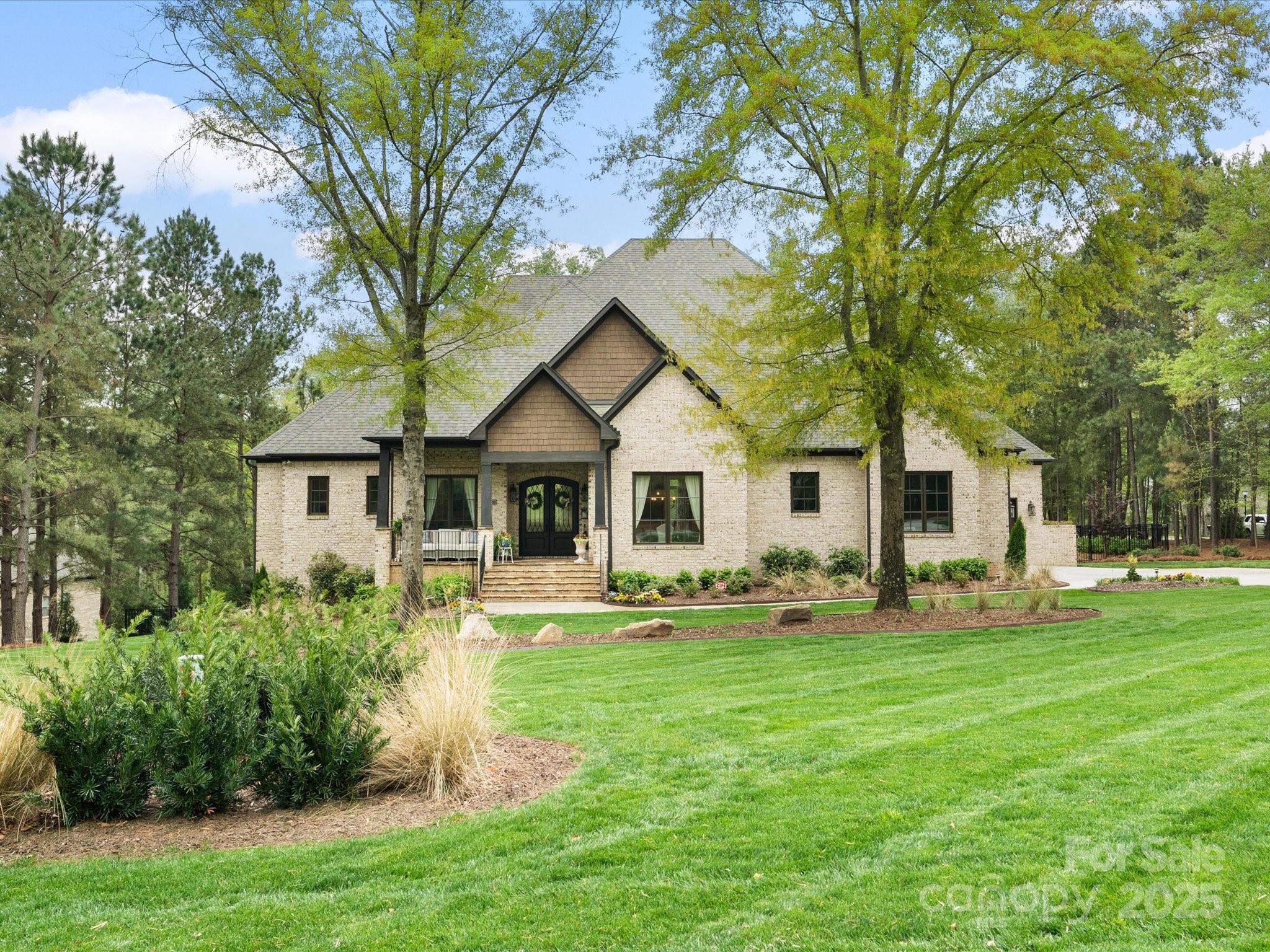 Stunning, move-in ready custom home in sought-after Millstone Creek! Nestled on a lush 1.672-acre estate lot, this home boasts luxurious upgrades and high-end finishes throughout. Welcoming flagstone front porch with double iron doors opens to rich hardwoods, custom millwork, coffered-ceiling great room with fireplace and built-ins. The open-concept kitchen impresses with a large island, marble counters, decorative backsplash, upgraded ceiling-height cabinets, walk-in pantry, and butler's pantry. Owner’s suite on main with spa-like bath, freestanding tub, large walk-in shower, and custom closet connects to laundry. Three additional bedrooms on main (one used as office, one ensuite). DropZone and office niche. Upstairs bonus/bedroom with full bath and walk-in closet—ideal guest suite. Incredible walk-in storage. Covered back porch, paver patio, and fire pit perfect for entertaining. Oversized 3-car garage. Whole house generator. Every detail designed for comfort, style and convenience.