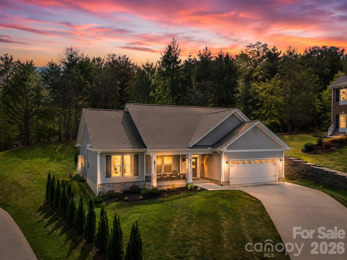 Tucked away at the end of a quiet cul-de-sac in the highly sought-after Wittenburg Springs subdivision, this beautifully crafted late-2023 home offers the perfect blend of modern comfort, thoughtful design, and everyday convenience. From the moment you arrive, the attractive landscaping and welcoming double-door entry create a warm first impression, inviting you to step inside and feel right at home.

Once inside, you'll immediately appreciate the light-filled open floor plan, soaring vaulted ceilings, and stunning floor-to-ceiling rock fireplace with gas logs that serves as the heart of the home. Whether you're hosting family and friends or enjoying a quiet evening in, this space was designed for gathering, relaxing, and making memories.

The kitchen seamlessly connects to the living and dining areas and features granite countertops, a large center island, ample cabinetry, and durable luxury vinyl plank flooring throughout the main living spaces. The thoughtfully designed split-bedroom floor plan provides privacy for the primary suite while creating comfortable spaces for family members or guests.

Built with modern living in mind, this home offers energy-efficient construction and features an encapsulated crawlspace with dehumidifier, a hybrid heat pump water heater, wide 36-inch doorways, minimal entry steps, and additional storage above the attached two-car garage. The garage is also pre-wired for an electric vehicle charger, providing added convenience for EV owners and future-ready living.

One of the property's most desirable features is the backyard. Backing to a natural wooded area, the outdoor space offers a sense of privacy that's becoming increasingly difficult to find. Imagine enjoying your morning coffee on the patio, unwinding after a long day, or entertaining friends while surrounded by the peaceful sights and sounds of nature. The location is equally appealing, with convenient access to Players Ridge Golf Course and Twin Brothers Restaurant at the clubhouse, offering opportunities for golf, dining, and social gatherings just minutes from home.

While the setting feels private and tucked away, convenience is never far. Grocery stores, restaurants, and everyday essentials are just minutes away, while nearby Lake Hickory and marina access provide endless opportunities for boating, fishing, and weekend recreation. You'll also enjoy easy access to Hickory, making commuting, shopping, healthcare, and entertainment both convenient and accessible while still enjoying the peaceful setting of Taylorsville living.

Whether you're searching for your next chapter, looking to downsize without sacrificing quality, or right-size into a more manageable home that still offers style, comfort, and modern features, 41 Emerson Ct checks all the boxes. Move-in ready and thoughtfully designed for today's lifestyle, this home offers more than just a place to live—it offers a lifestyle. If you've been searching for a newer construction home with privacy, energy-efficient features, proximity to Hickory, Lake Hickory, golf, dining, and a prime location in Alexander County, this is one you won't want to miss.