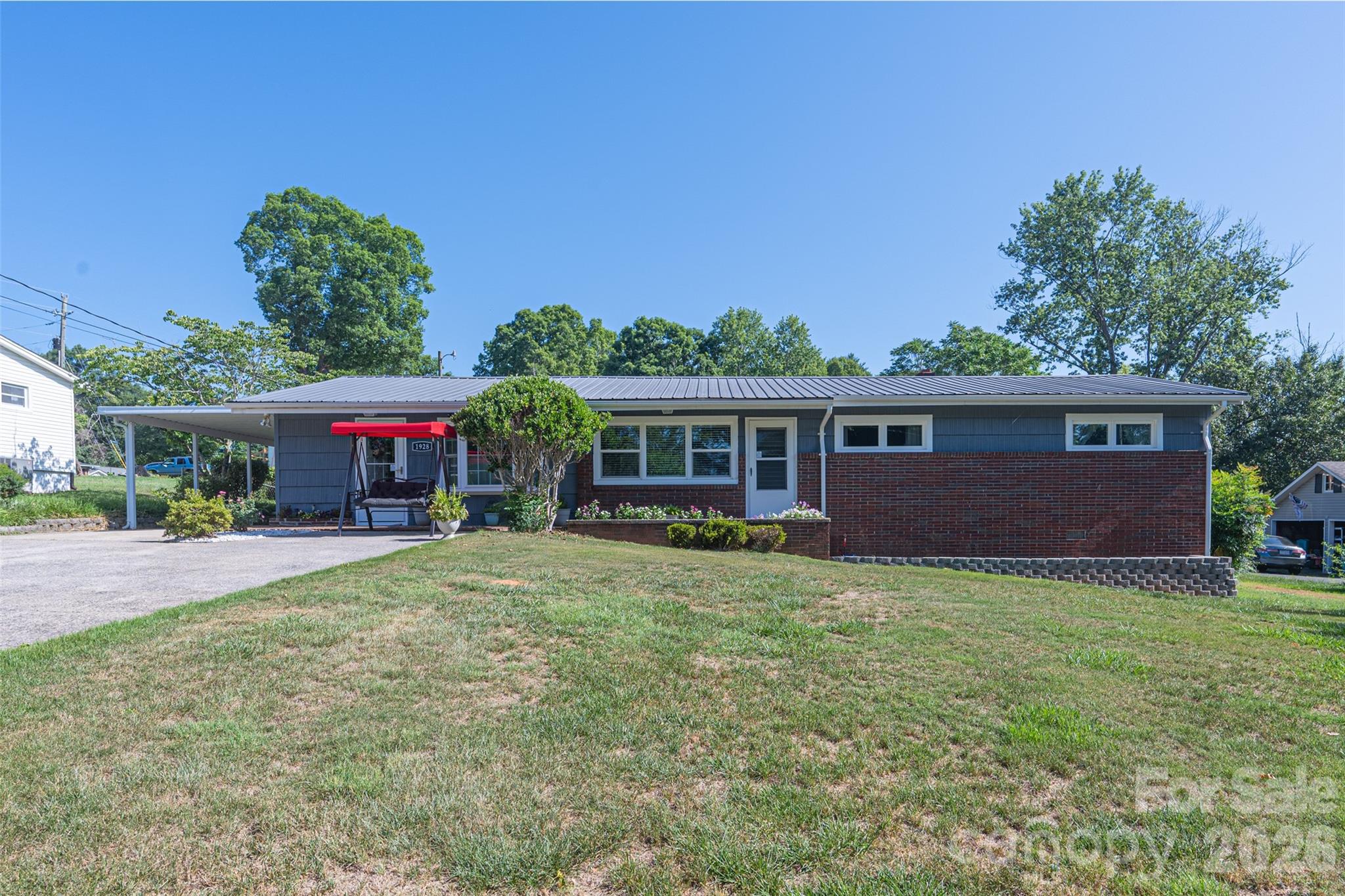 Move-In Ready 4-Bedroom Home with Extensive Updates!

Discover all the recent improvements in this thoughtfully updated 4-bedroom home, conveniently located with easy access to Hudson, Lenoir, Granite Falls, Hickory, and Boone.

The kitchen features updated countertops, freshly painted cabinetry with open shelving, a newer range, and all appliances convey. Adjoining the kitchen is a spacious living and dining great room designed for both comfortable daily living and effortless entertaining. Just beyond, the utility/laundry room provides a dedicated laundry space, abundant storage, and room for a second refrigerator or freezer.

Recent interior improvements include fresh paint, refinished hardwood floors in the living room and three bedrooms, updated bathrooms, new paneled interior doors, updated light fixtures, and replacement insulated windows throughout. With so many upgrades already completed, this home is truly move-in ready.

Step outside to enjoy the covered rear patio and covered carport, complemented by new exterior lighting, new front and rear exterior doors, and storm doors at both entrances. The large, fully fenced backyard offers plenty of room for pets, recreation, and outdoor gatherings. Two storage buildings remain with the property, including one wired with electricity.

Major system updates include a durable metal roof, newer gas furnace, central air unit, and gutters. The recently encapsulated crawl space carries a transferable warranty for added peace of mind. An added bonus: the home has been connected to the City of Lenoir sewer system, and the former septic system has been properly abandoned.

Don't miss this opportunity to own an updated, move-in ready home in a convenient location. Schedule your showing today!