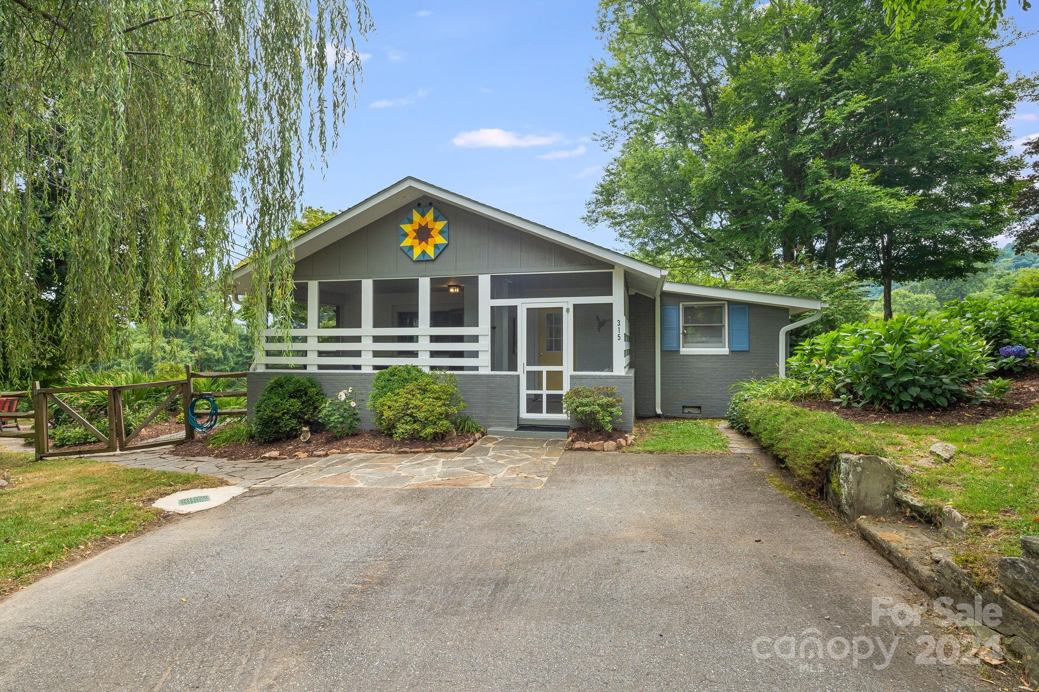 Meticulously maintained single-story farmhouse exudes charm with its updated Euro cottage aesthetic. The home is bathed in natural light, thanks to tall windows, skylights, and glass sliding doors. The inviting kitchen and dining area feature newer appliances and a gas range with vented hood. Rustic ceramic tile and wood flooring add warmth and character. Updates include newer carpet and renovated primary ensuite bath with a curbless shower. The screen-enclosed front porch invites relaxation and offers a sauna for unwinding. A bunkhouse can be used for storage or as an extra sleeping quarter. Property is surrounded by a newer wood split rail fence with welded wire, ensuring both beauty and security. Stunning landscaping and long-range views can be enjoyed from the wrap-around deck, ideal for relaxing and entertaining. Outdoor space includes a cozy firepit and serene gardens. This home seamlessly blends classic charm with modern conveniences, creating a warm and inviting atmosphere.