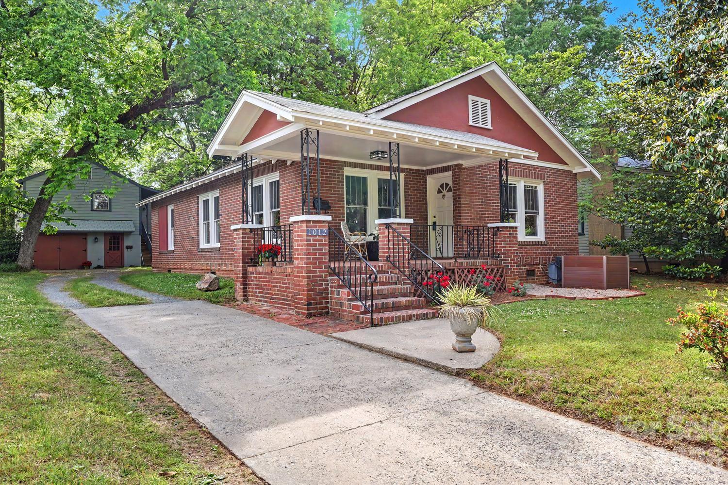 This true 1930s bungalow beauty, set in the heart of NoDa, exudes timeless character; perfectly blending classic architecture with modern functionality. This home boasts a bright and airy floor plan with open-concept for Living, Dining, and Kitchen. Original hardwood floors, NEW windows, updated kitchen features NEW stainless stove, hood and dishwasher, sleek countertops and pass through to dining room to make entertaining a breeze. Primary bedroom is spacious with en suite bathroom and walk in closet. The property includes a detached one car garage featuring a versatile and sizeable workroom /studio space, ideal for creative projects or a home workshop. Above, a delightful spacious 1-bedroom, 1-bath apartment with living room and eat -in kitchen offers a cozy and inviting retreat,perfect for guests, extended family, or rental income. The unit has it's own entrance, laundry area and private yard + separate water and electric meters from the main house. It also has a stellar rental history.
Set on a large, deep lot and located on one of the most popular streets in one of the city’s most sought-after areas; you will enjoy privacy while still being a stones throw to all the action. This neighborhood buzzes with energy and lifestyle appeal. Enjoy a rich mix of restaurants, boutique shops, and live music venues just steps from your door, making every outing an opportunity to explore, dine, and socialize. A true hub for culture, entertainment, and community, it’s a place where convenience meets charm and every day feels like a local adventure.