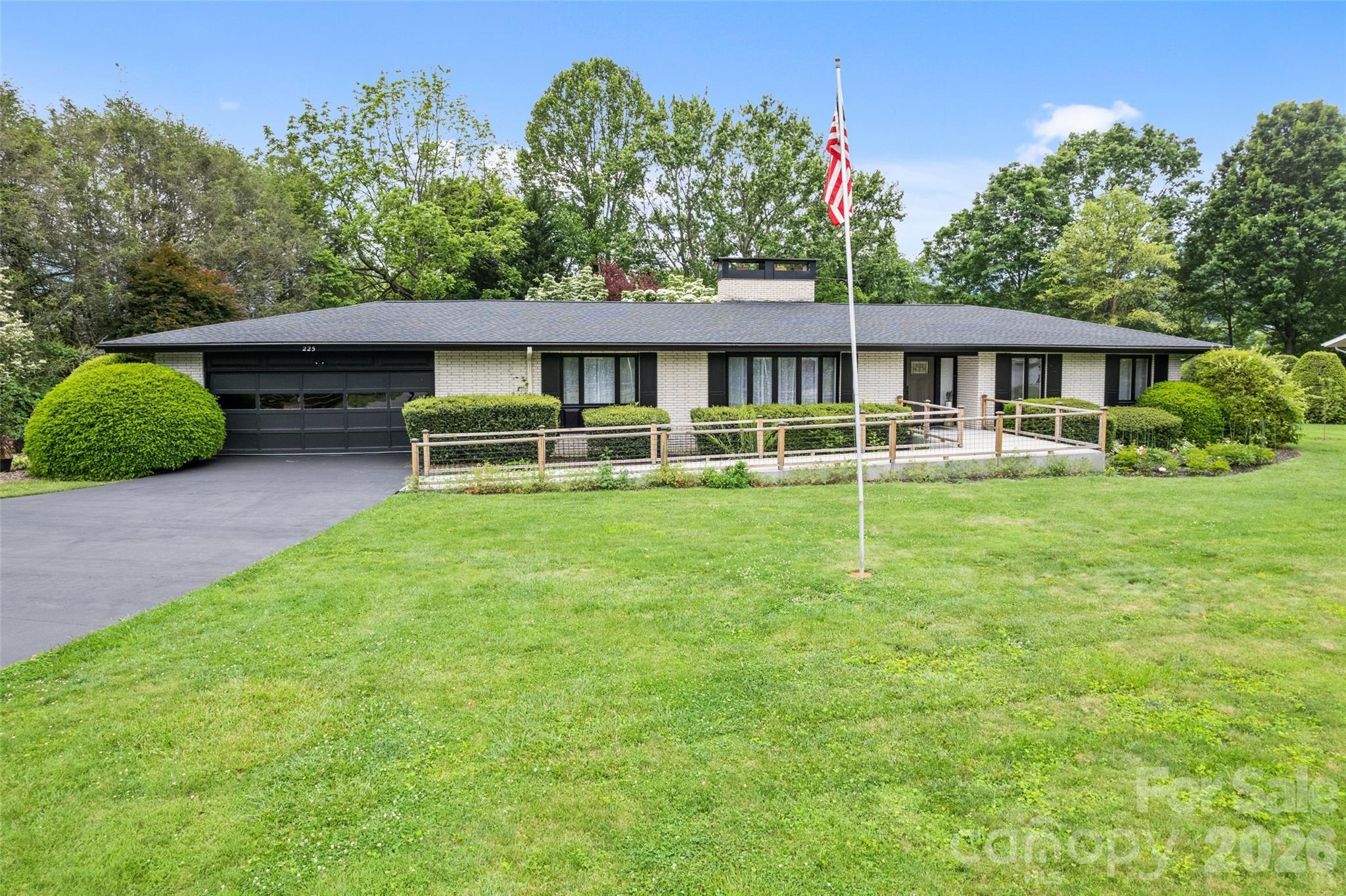 Experience elevated mountain living with the rare combination of in-town convenience and a true, down-to-the-studs renovation in this exceptional Waynesville property. Completely reimagined from 2022–2024, this home offers the peace of mind and quality of essentially new construction with every detail thoughtfully upgraded. Set on a level acre with year-round mountain views, the home showcases soaring cathedral ceilings across the living, great room, and kitchen—creating a bright, open, and inviting atmosphere. Two beautifully appointed kitchens feature quartz countertops and modern finishes, complemented by custom-tiled bathrooms and durable luxury vinyl flooring throughout. Designed for both everyday comfort and entertaining, the flexible layout includes 5 bedrooms, a dedicated theater room, game room, second kitchen/wet bar, and additional flex space to suit your needs. Step outside to enjoy a spacious patio, established garden, fruit trees, and a fire pit—perfect for relaxing or hosting under the stars. Major system upgrades add lasting value, including dual-zone HVAC, a 2020 roof, three propane fireplaces, and updated appliances including dryer, range, and water heater. A 2-car garage with additional storage completes the package. Furniture is available, making this a potential turnkey opportunity. All of this just 2–3 miles from downtown Waynesville, with Spectrum high-speed internet and TV available.