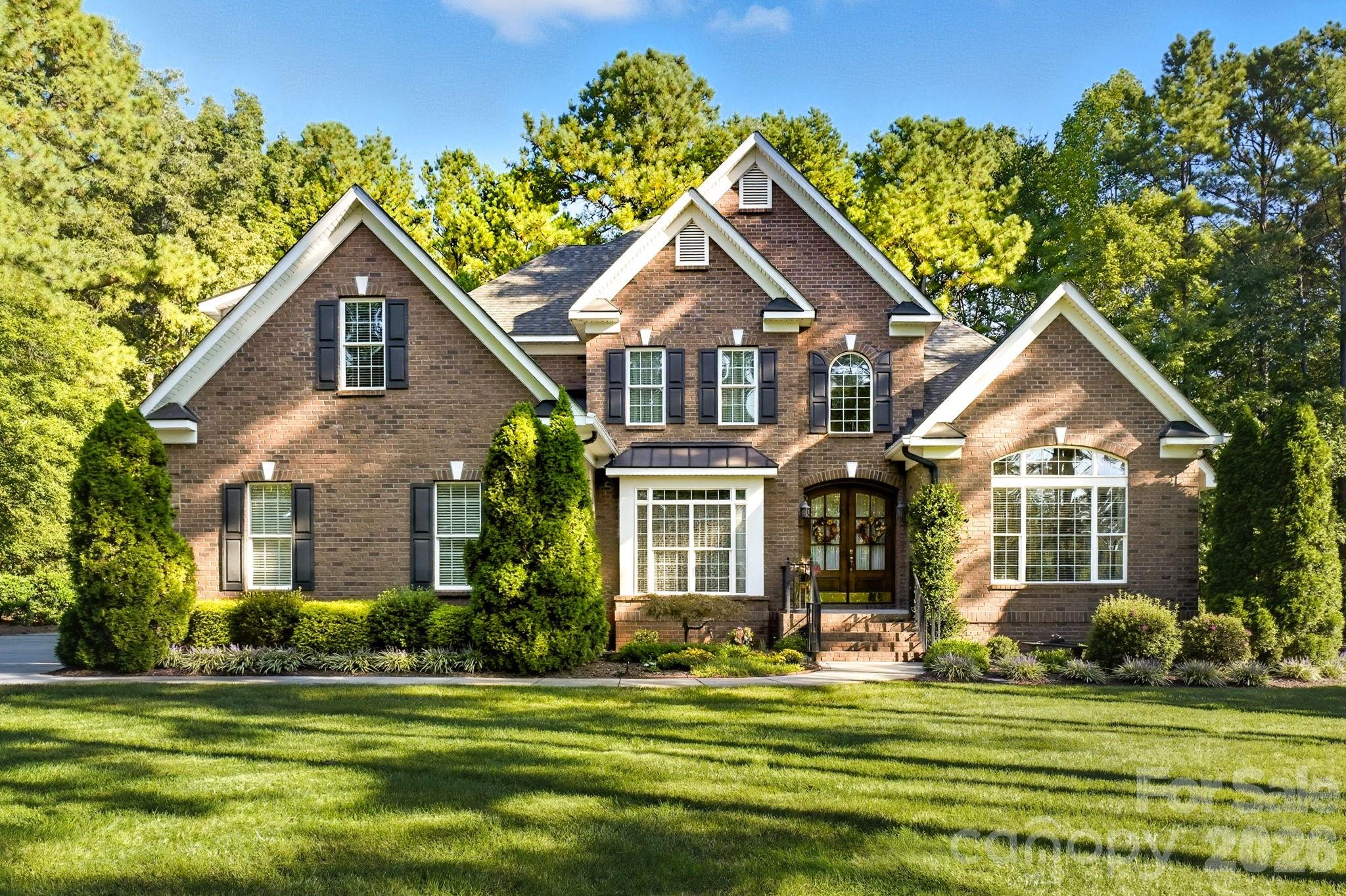 Tucked inside the gated Pebble Bay community, this custom-built home sits on over an acre and offers a rare combination of Lake Norman access, privacy, and flexibility. Residents enjoy gated access to a community boat ramp and gated vehicle storage (subject to availability), making lake life easy without the cost of full waterfront ownership.

A truly unique feature of this property is the adjacent 22’x46’ fully insulated and conditioned building. With two separate rooms, individual entrances, two-zone heating and cooling, 240V electrical service, and its own security system, this space is ideal for a garage, office, workshop, studio, gym, hobby room, or climate-controlled storage—options rarely found in this area. 500 sf of the building is HLA and 535 sf is Shop/garage (Non-HLA). It is listed as 2nd living quarters but has not bath or kitchen.

Inside, the home is designed for comfortable everyday living with thoughtful upgrades throughout. The main level features wide solid oak flooring, a welcoming family room with built-in bookcases and a gas fireplace, and a separate formal sitting area ideal for quiet evenings or entertaining. The first-floor laundry room adds convenience, while stone flooring in the bathrooms and laundry enhances durability and style.

The kitchen is a standout, equipped with custom cherry cabinetry, a large center island, pull-out shelving, a corner Lazy Susan, and a six-burner gas cooktop—perfect for both casual meals and hosting gatherings. Enjoy breakfast in the cozy nook or larger dinners in the formal dining room.

The primary suite on the main level offers a peaceful retreat with two walk-in closets and a spa-style bath featuring a Jacuzzi type tub, with stone surround and a walk-in shower. A second main-level bedroom is conveniently located near a full bath, ideal for guests or multigenerational living. Upstairs, two additional bedrooms with generous closets, a third full bath and a  flex room room provide flexible space for family, hobbies, or work-from-home needs.

Outdoor living is easy with a maintenance-free 20’x24’ Trex deck overlooking level, landscaped grounds supported by an eight-zone in-ground irrigation system. The sealed crawl space and gutter guard system add long-term peace of mind.

Additional highlights include 400-amp electrical service, wiring for a whole-house generator, in-ground propane tank, water softener with pre-filter, three electric garage door openers, ceiling fans in eight rooms, ceiling speakers with additional pre-wiring, a second gas fireplace and multiple walk-in and floored attic storage spaces. 

Homes offering this combination of acreage, community lake access, and a fully conditioned auxiliary building are rarely available in Pebble Bay.
