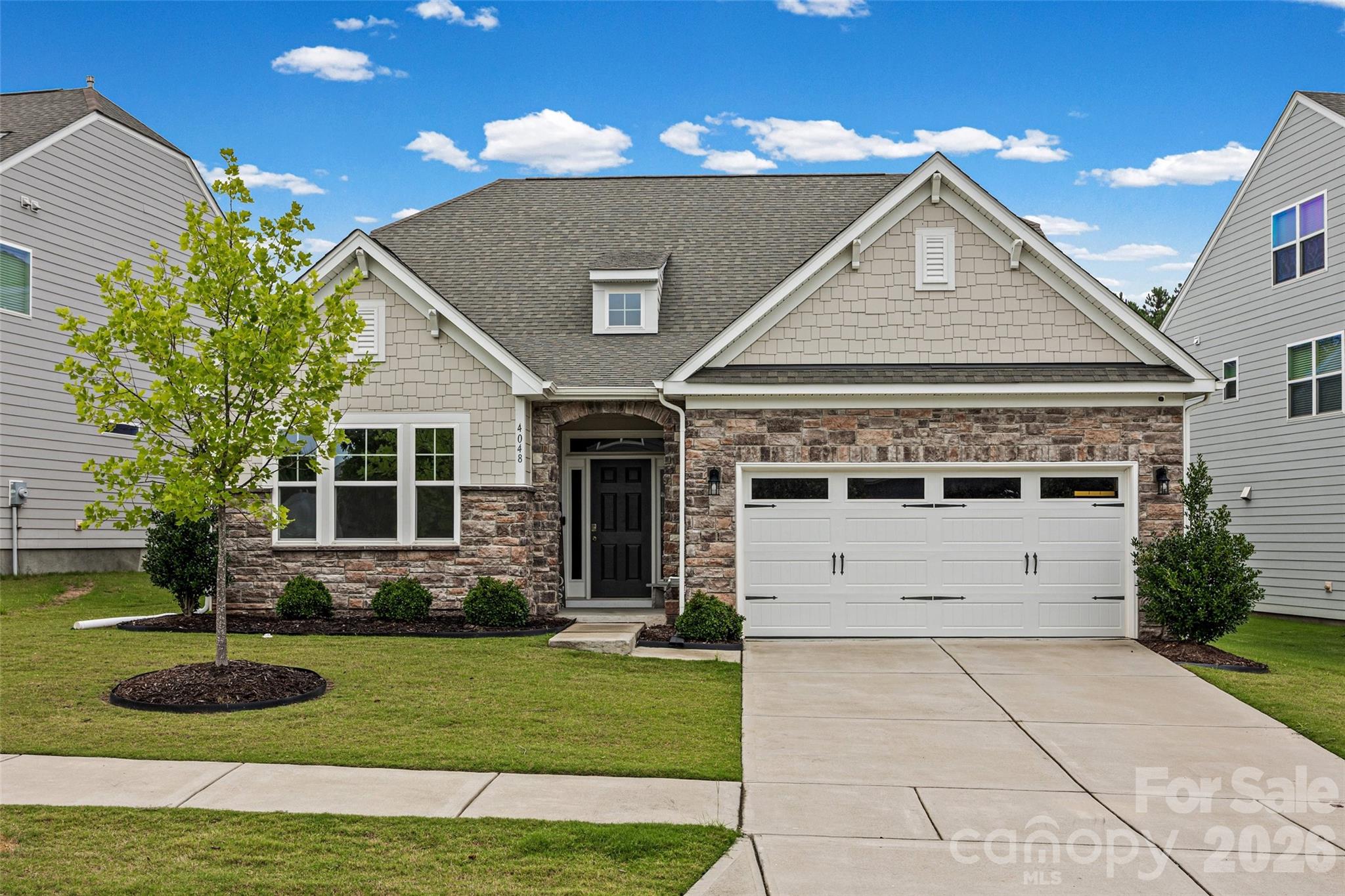 Welcome home to this beautifully designed 1.5-story residence offering the perfect blend of comfort, style, and exceptional indoor-outdoor living. With 3 bedrooms, 3 full bathrooms, and a thoughtfully designed open floor plan. This home is ideal for both everyday living and entertaining.

Just off the entry, you'll find a private office with elegant double glass French doors, creating the perfect space to work from home, study, or enjoy a quiet retreat.

The heart of the home is the gourmet kitchen, featuring stunning quartz countertops, abundant cabinetry, a double oven, and plenty of prep space for the home chef. Overlooking the spacious living room with its cozy gas fireplace, this open-concept design creates the perfect setting for entertaining and everyday living.

Retreat to the luxurious primary suite on the main level, complete with a beautifully upgraded spa-inspired bathroom designed for relaxation. An additional main-level bedroom and full bath provide flexibility for guests or additional family living space.

Upstairs, you'll find a spacious loft that offers endless possibilities as a media room, game room, or second living area, along with a private bedroom and full bathroom.

The backyard is truly an entertainer's dream and an extension of the home's living space. Start your mornings on the screened-in porch with a cup of coffee, then spend your evenings gathered around the built-in fire pit on the expansive oversized paver patio. The perfectly positioned hot tub conveys with the home, creating a private retreat where you can relax under the stars. Whether hosting family and friends or enjoying a peaceful evening at home, this thoughtfully designed outdoor oasis offers the perfect setting for every occasion.
Beyond the home, you'll enjoy outstanding community amenities, including a beautiful resort-style pool, clubhouse, fitness center, tennis courts, ball fields, and scenic walking trails—offering endless opportunities for recreation, relaxation, and an active lifestyle.

Combining elegant finishes, functional living spaces, exceptional outdoor entertaining areas, and incredible community amenities, this move-in-ready home truly has it all. Don't miss the opportunity to make it yours!
