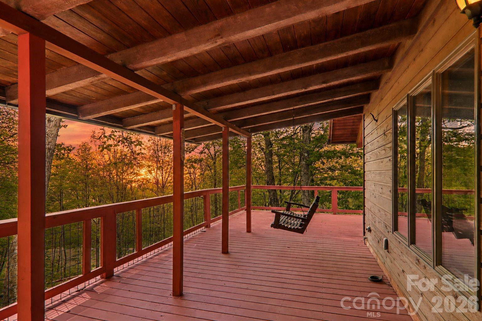Inside the gates of Wolf Laurel Resort, this mountain home feels like an invitation to slow down and settle into the beauty of the land. Set at 4,240 feet in elevation within Wolf Laurel’s 5,300 acre gated, high elevation mountain community, 101 Oak Ridge offers the gift of cool mountain air, extra breathing room, and a setting that feels deeply connected to the surrounding woods and wildflowers. The property sits on a combined double lot with one HOA fee, offering added privacy and space in a truly special mountain setting.
The 3-bedroom layout is practical and welcoming, with one bedroom and a full bath on the main level and two additional bedrooms with a full bath upstairs. The lower level recreation room opens to truly special outdoor living areas thoughtfully designed as a loop around the home, creating a natural flow through decks, gathering spaces, and wildflower filled surroundings. It is the kind of outdoor living that makes you want to linger, coffee in the mornings, quiet afternoons, dinner outside, and evenings listening to the mountain settle down.
A detached workroom offers another layer of possibility. Keep it as a workshop, or reimagine it as an art studio, yoga studio, office, or cozy mountain hangout. Surrounded by the beauty of Pisgah National Forest and close to the Appalachian Trail, Wolf Laurel is a nature lover’s paradise, with hiking, mountain views, wildlife, and outdoor adventure woven into everyday life. The Wolf Laurel Village Club membership conveys with the sale, adding access to beloved community amenities and gathering spaces. With its flexible layout, generous double lot setting, incredible outdoor living, and location in one of the region’s most cherished gated mountain communities, this home is ready for full-time living, a mountain getaway, or a place where family and friends can gather season after season.