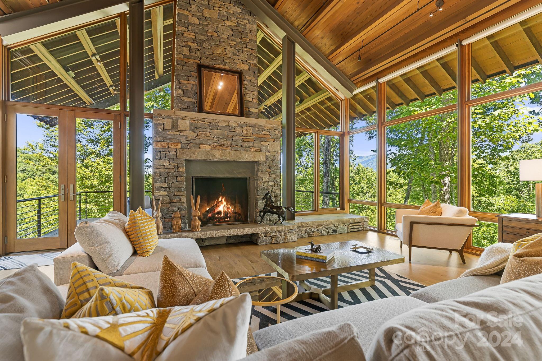 This Carlton Edwards-designed, award winning masterpiece is absolutely stunning. As one of the few equestrian lots in Balsam, with nearly four acres and an acre of pasture land, this opportunity would allow you to have a barn in your backyard with direct access to 40 miles of trails. For those without horses, just enjoy the incredible views, privacy and flat land that your family can actually use and enjoy. The mountain modern design has amazing design details of wood, stone, glass and steel throughout. With two beautiful covered outdoor porches, featuring wood burning fireplaces, you can enjoy the outdoors year round while taking in the gorgeous landscape. Pictures don’t do this home justice. It’s a must see in person. Balsam Mountain Preserve is a private 4,400 acre club community with 3,200 acres of conservation land and completed amenities including an Arnold Palmer golf course, The Summit House and Mine Tavern restaurants, wellness and equestrian centers and 40+ miles of trails.