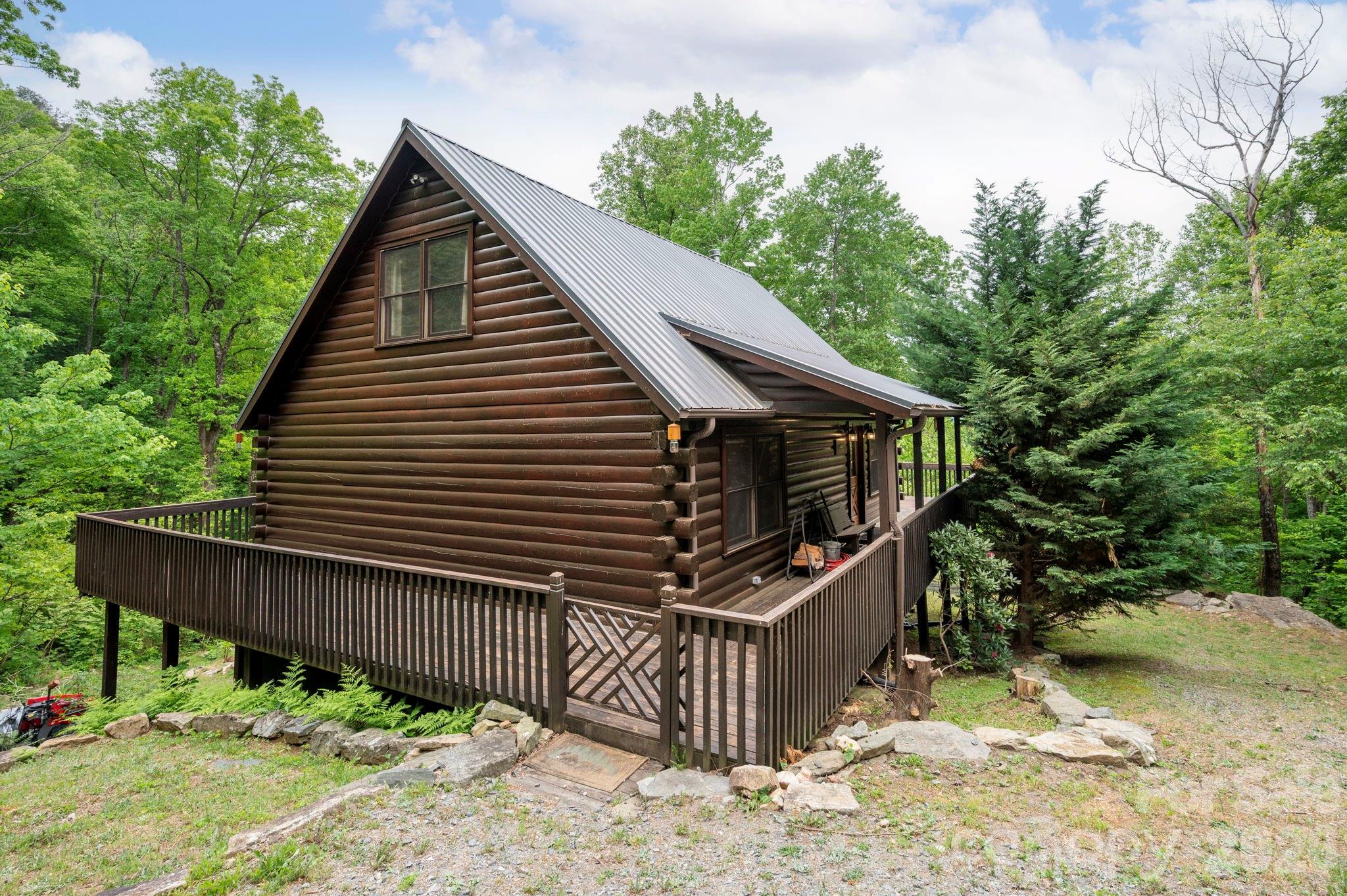 Tucked among whispering trees and rolling mountain views, this charming 2-bedroom (2 bedroom septic), 2-bath cabin offers the kind of peace and privacy that’s hard to find—and even harder to leave. The loft is currently being used as a 3rd bedroom with it's own private full bathroom. Nestled on 26 serene acres (with the option to with 18 acres only —MLS 4368235), this property is more than just a home; it’s a retreat for the senses. A cheerful stream winds its way through the landscape, catching sunlight as it flows, while birdsong fills the air and a gentle breeze moves through the trees. Whether you’re looking to build, expand, or simply rest, this land welcomes imagination and possibility, with multiple potential homesites ready for your vision. Step inside and you’ll find a bright, open living space filled with warmth and natural light. Vaulted ceilings create a sense of airiness, while the open-concept design invites connection and comfort. The main-level bedroom offers easy convenience, while upstairs you’ll discover another spacious bedroom, a full bath, and a flexible bonus room—ideal for guests, a creative studio, or a quiet home office with views that inspire. The full, unfinished basement—complete with garage access—adds even more potential. It’s a blank canvas for storage, a workshop, or future finished living space. Thoughtful details throughout the home, like two high-end hypoallergenic air purifiers (one LED and one electric), enhance the feeling of freshness and care that defines this mountain hideaway. Step outside, and it’s easy to see why this setting feels so special. The land unfolds in gentle layers of forest and meadow, offering beauty in every season—from the first blooms of spring to the gold and crimson hues of autumn. The cabin sits along a quiet street with only a few neighbors nearby, creating a sense of true seclusion without leaving you isolated. Here, you can spend mornings by the stream, afternoons exploring the trails that weave through your property, and evenings watching the stars rise over the ridgelines. Whether you’re dreaming of a weekend getaway, a peaceful homestead, or a forever home tucked deep in nature’s embrace, this property offers a rare chance to live in harmony with the mountains—while having the space, beauty, and flexibility to grow. This isn’t just a cabin—it’s an invitation to slow down, breathe deeply, and come home to the mountains.