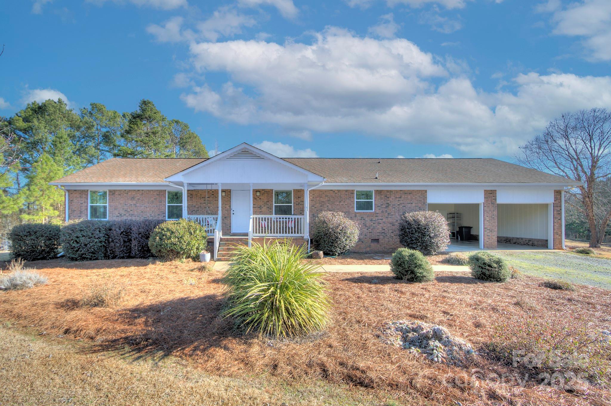 Welcome to a fantastic and comfortable home located on 3+ acres and NO HOA!  Bring the landscaping equipment...you will find the perfect detached 1155 sf garage which consists of 2 garage bays and additional workshop area PLUS 2 carport bays (611 sf).  Brick single story home with 23'10x18'6 great room invites friends and family to hang out around the wood burning fireplace w/ large hearth.  Primary bedroom w/ ensuite bath (dual vanity & large shower & separate make up counter). Function laundry room w/ wall of cabinetry - seller finished laundry; however, footprint original to house.  Looking to unwind at end of a busy week? Huge firepit invites you to start a fire and RELAX! Refrigerator, washer & dryer in house and refrigerator & freezer in shop convey.