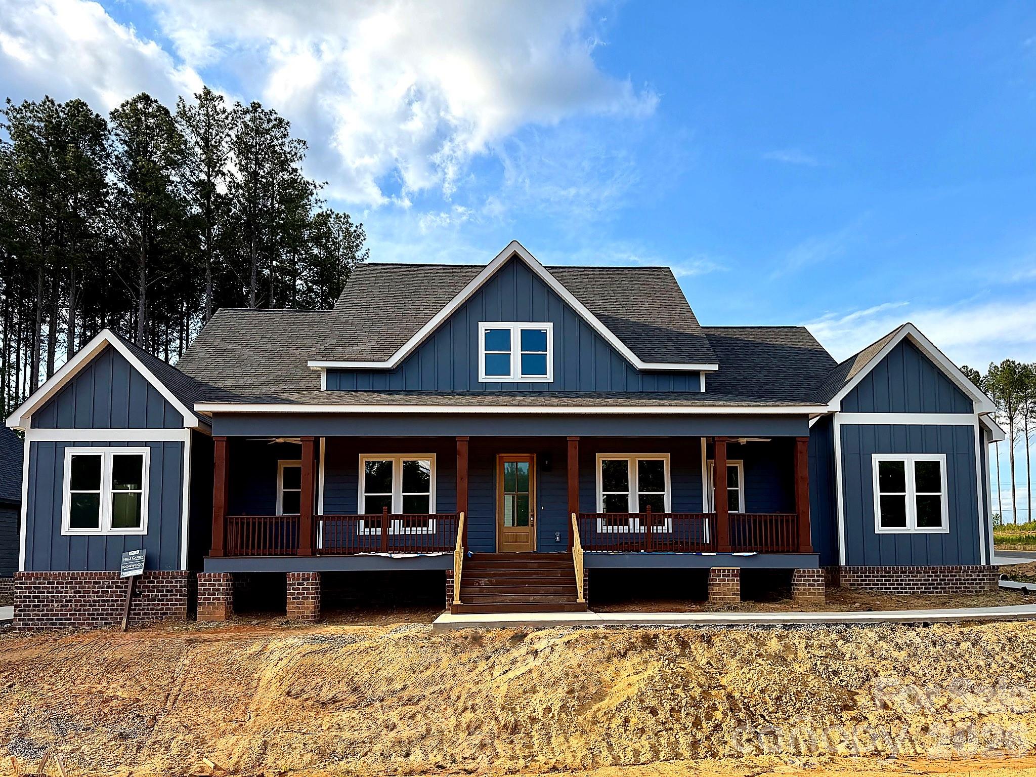 Luxury Custom Farmhouse Spec in Mills Garden at Woodstone. This beautiful new construction is set on a 0.29-acre lot and is set to be completed on 6/19/2026.  Woodstone Communities “Ironwood” is a single-story ranch, approximately 2,802 sq ft with 4 bedrooms plus an office, 3.5 baths designed with upscale finishes and a thoughtful layout. The open chef’s kitchen is built for entertaining. It features custom cabinetry, upgraded quartz countertops throughout, gourmet Z-Line gas range and appliances. This opens to your living room area that features a gas fireplace, vaulted ceilings and a huge sliding panel patio door that opens to your large, covered porch with Trex decking allowing for indoor/outdoor entertainment. The primary suite offers a huge bedroom with vaulted ceilings, spacious walk-in closet with custom built-ins and dresser drawers, and a spa-inspired bath with soaking tub and custom tilework. Additional highlights include huge plank LVP flooring, tile and carpet flooring, custom wood shelving throughout. Exterior features Hardie siding with beautiful foundation brick veneer for lasting curb appeal. Includes a huge 3-car garage, sealed crawlspace foundation equipped with a dehumidifier.