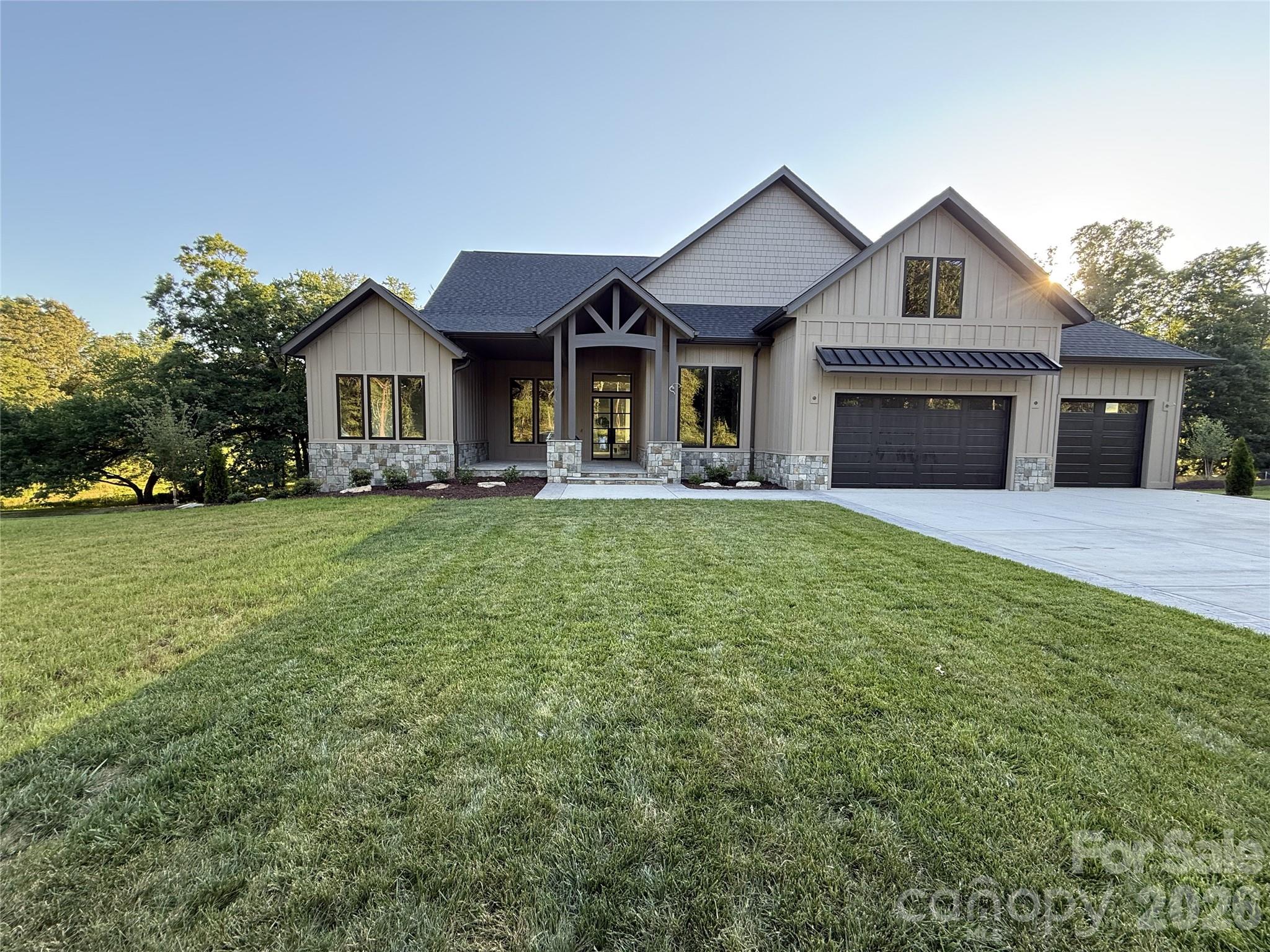 Situated on a sprawling 1.78-acre lot just off Cane Creek Road in Fletcher, NC, this stunning residence offers over 3,000 square feet of meticulously designed heated living area. The interior showcases soaring high ceilings and a thoughtful layout featuring two separate front offices, perfect for modern professional needs. The heart of the home is a high-end kitchen complete with a premium gas range, a dedicated coffee bar, and sophisticated finishes that extend into the luxurious bathrooms. Upstairs, a versatile bonus room serves as a private bedroom suite with its own full bath. Outdoor living is redefined by a large screened-in back porch, while the oversized three-car garage provides over 800 square feet of space. Notable storage solutions include a massive crawl space with high ceilings and a large section featuring a poured concrete floor, ensuring every organizational need is met in this exceptional Fletcher estate that perfectly blends luxury with functional mountain living.