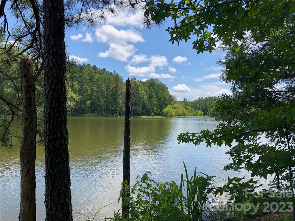 Features about approximately  feet of lake waterfront on almost 4 Acres ...truly a “rare find” & presents a possibility for retreat or private getaway for those wonderful "get together" moments. Lake front acreage on one of SC’s hidden jewels – this lot is spacious, tranquil and private but close to Columbia and Charlotte. …surrounded by many hardwoods and 60 'pine forest. Spectacular views…a tremendous opportunity for your own private or entertaining getaway Including a Dock!  Minimum buildable home is 1,500 sq. ft.   Septic is Approved for 4 Bedroom home until April 8, 2025. If you enjoy a private and peaceful environment…your spot on a truly private lake with boat restrictions with paddle or electric motor boats only for fishing, sailing, paddle boating and kayaking. This is truly a secluded but yet convenient location near traffic corridors, shopping, medical and recreation.