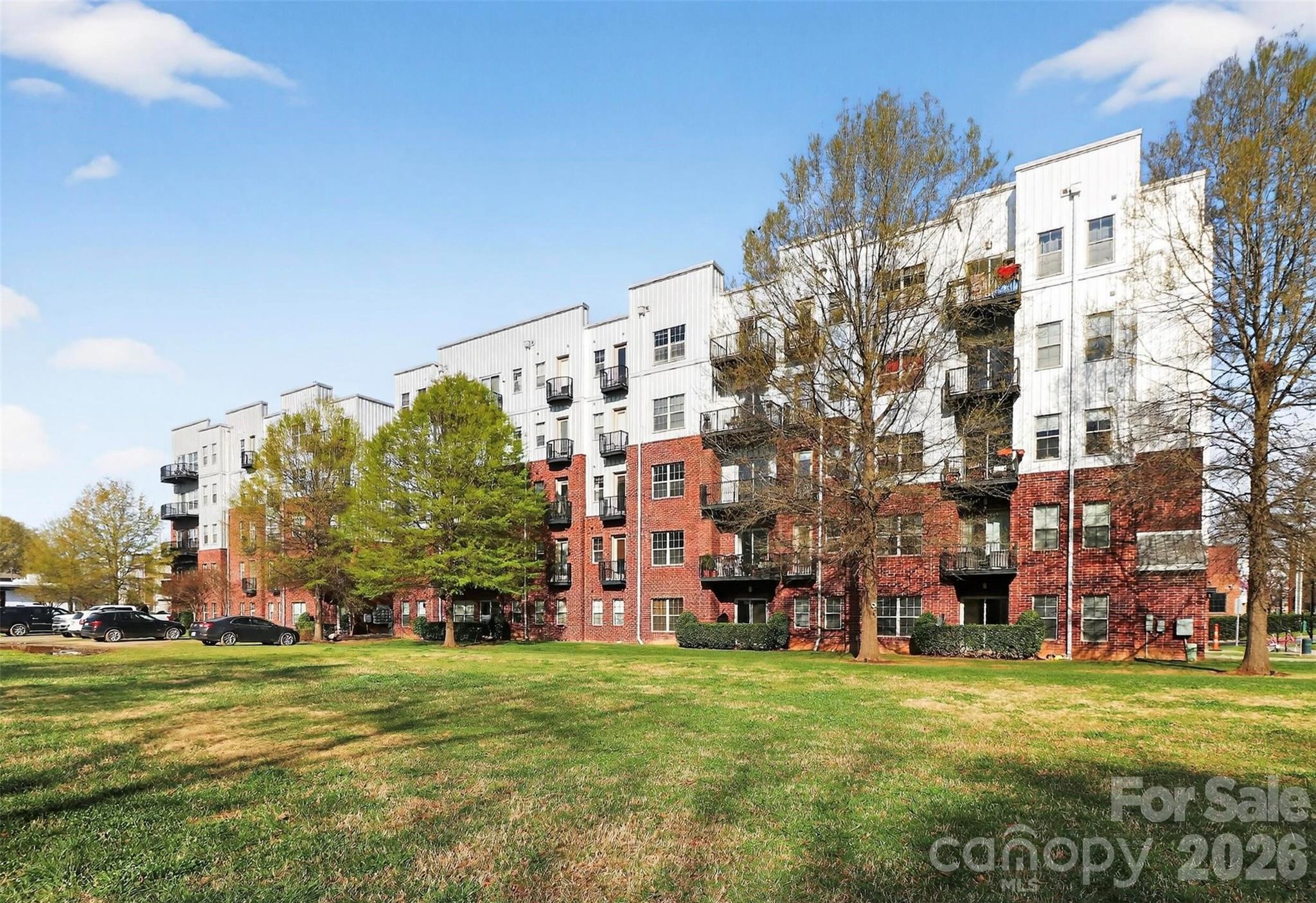 Modern 1BR condo in NoDa featuring an open layout, high ceilings, and exposed ductwork. Interior highlights include polished concrete floors, granite countertops, stainless steel appliances, and a built-in workspace. Large windows and an oversized private balcony provide abundant natural light and views of green space.

Appliances including refrigerator, washer, and dryer convey. Notable updates include HVAC (2022), dishwasher (2024), and recently installed smoke and carbon monoxide detectors.

Located in the 28th Row community with access to a rooftop terrace and pet-friendly outdoor space. Close to Optimist Hall, breweries, dining, shopping, and light rail access, offering a vibrant city lifestyle.

Some images include virtual staging. Some photos have been virtually rendered.

Significant price improvement – best value in the building.