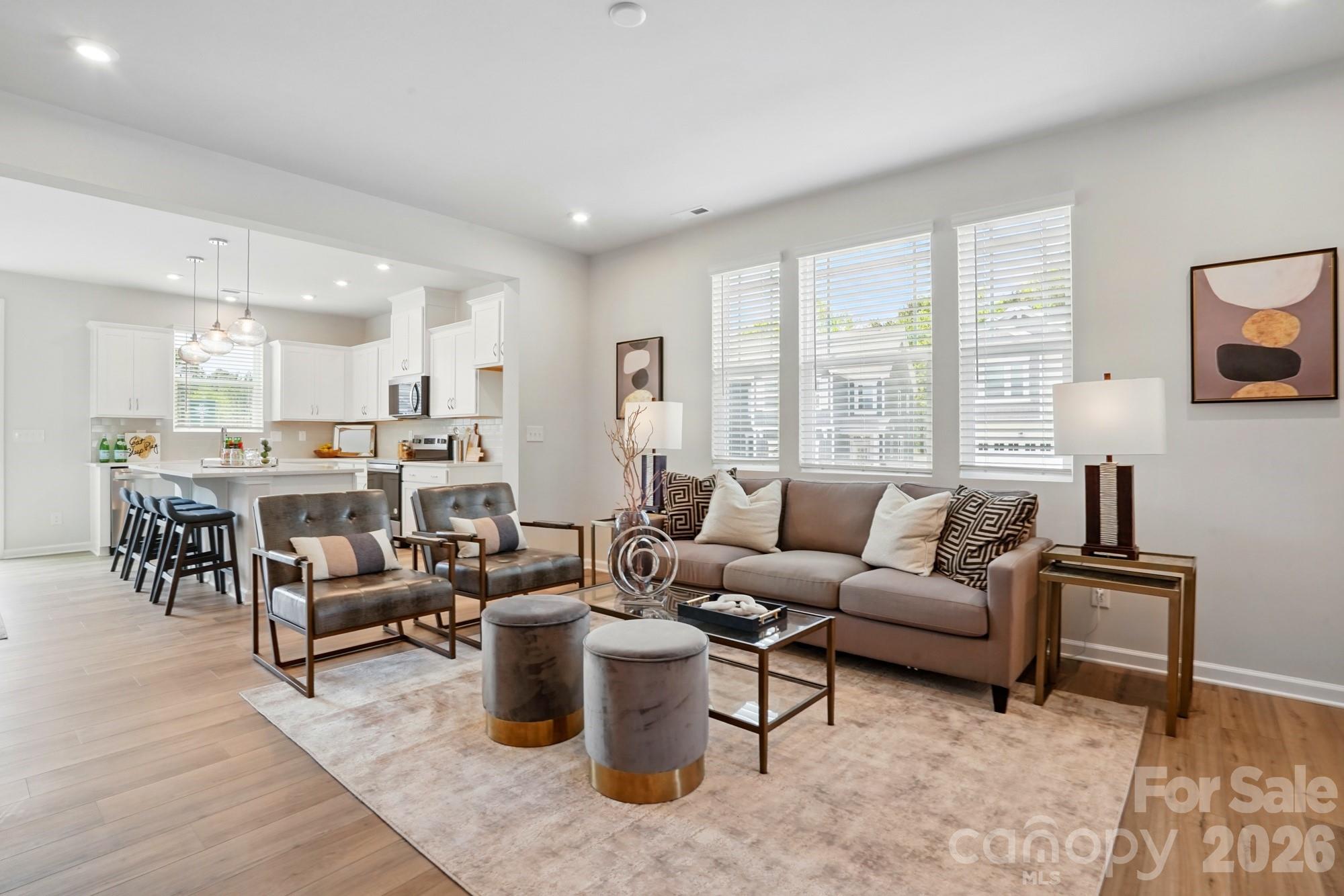 Welcome to The Amira, a beautifully designed townhome offering modern comfort and stylish living.  The first floor features a welcoming front porch and foyer, leading to an open and inviting gathering room.  The spacious kitchen boasts a walk-in pantry, ample counter space, and flows seamlessly into the breakfast dining area.  A powder room and access to the one-car garage add convenience, while the patio provides a perfect out door retreat.  

Upstairs, a large loft offers flexible living space.  The owner's suite is a true sanctuary with a walk-in closet and an en-suite bath featuring a walk-in shower with seat and dual vanity.  Two additional bedrooms, a full-size bathroom, linen closet, and laundry room complete the second floor. 

With its thoughtful layout and modern finishes, The Amira is designed for effortless living.