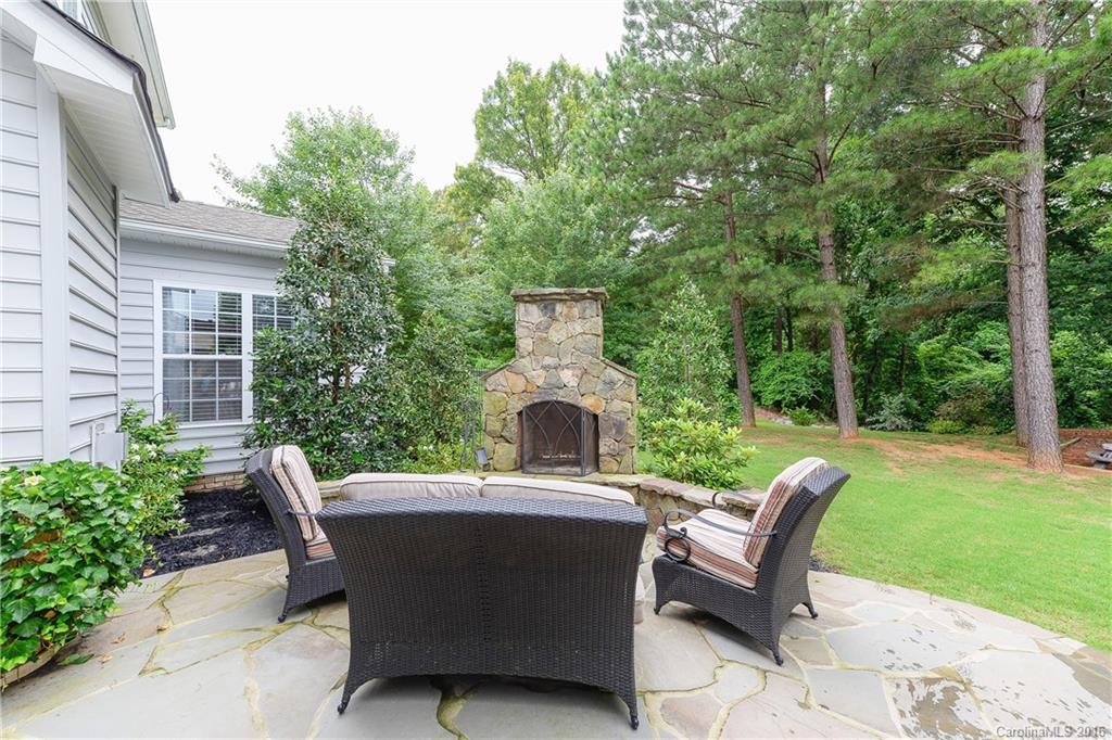 Incredibly detailed home in highly desired Fort Mill community just 2 miles from I-77.  Private backyard backs to woods with custom stone patio, pergola, and fireplace.  Interior upgrades include butler's pantry with built in wine fridge & cabinets, high end hardwood floors, granite countertops, cast stone fireplace, gourmet kitchen with double ovens & stainless appliances, custom shelving, surround sound, and the list goes on! Award winning schools and great community amenities.