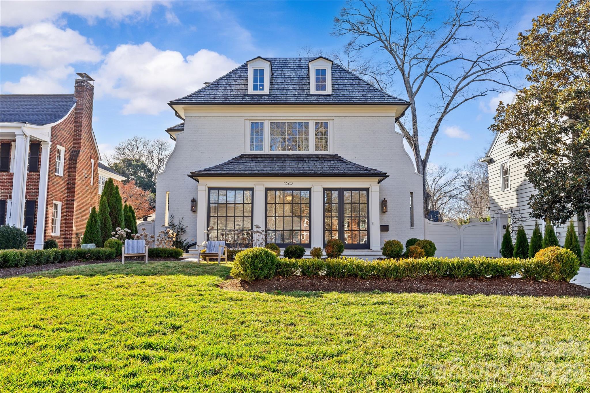 Stunning custom home built in 2022 by Knight Residential Group, ideally situated in the heart of highly sought-after Eastover. Offering nearly 6,000 square feet of refined living space, this 5 bedroom, 5.5 bath residence showcases elevated designer finishes, 10’+ ceilings, white oak flooring and exceptional attention to detail throughout. The main-level primary suite features dual custom walk-in closets and a spa-like bath with soaking tub, oversized steam shower, and marble surfaces. The chef’s kitchen features custom cabinetry, quartzite countertops and backsplash, SubZero and Wolf appliances, and an adjacent scullery—perfect for entertaining. Kitchen opens seamlessly to the family room with cozy cast stone fireplace and sunny dining area. Additional highlights include the front gallery/foyer, private office, built-in bar, and functional mudroom. The second level offers 3 generous bedrooms with en-suite baths, loft workspace, playroom, and expansive laundry. The third level provides flexible bonus, fitness, and guest spaces plus a full bath.  Outdoors, enjoy the covered rear patio equipped with in-ceiling heaters and wood-burning fireplace overlooking the flat, manicured yard. Detached garage provides wonderful additional storage. Just minutes to Uptown and SouthPark, this home delivers luxury, comfort, and convenience in one of Charlotte’s most coveted neighborhoods.