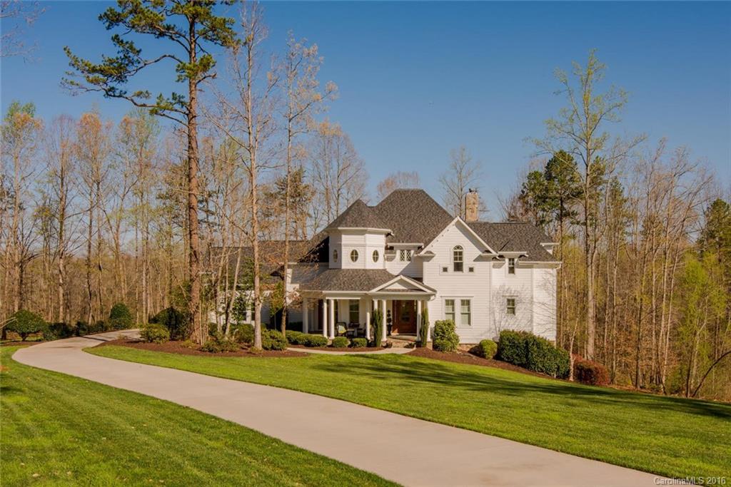 Scenic private wooded setting on over 2 acres with golf course view. Generous foyer opens to 2-story great room with fireplace and french doors to terrace. Sunny formal dining room. Charming kitchen with large island, breakfast nook opens to sunroom. Master suite on main. Three creative bedrooms and bonus room upstairs. Lower level with fireplace, built-ins and kitchen.Covered terrace to patio with fireplace. Hardwood floors on main. Inviting warm spaces and open for entertaining. Lovely spaces.