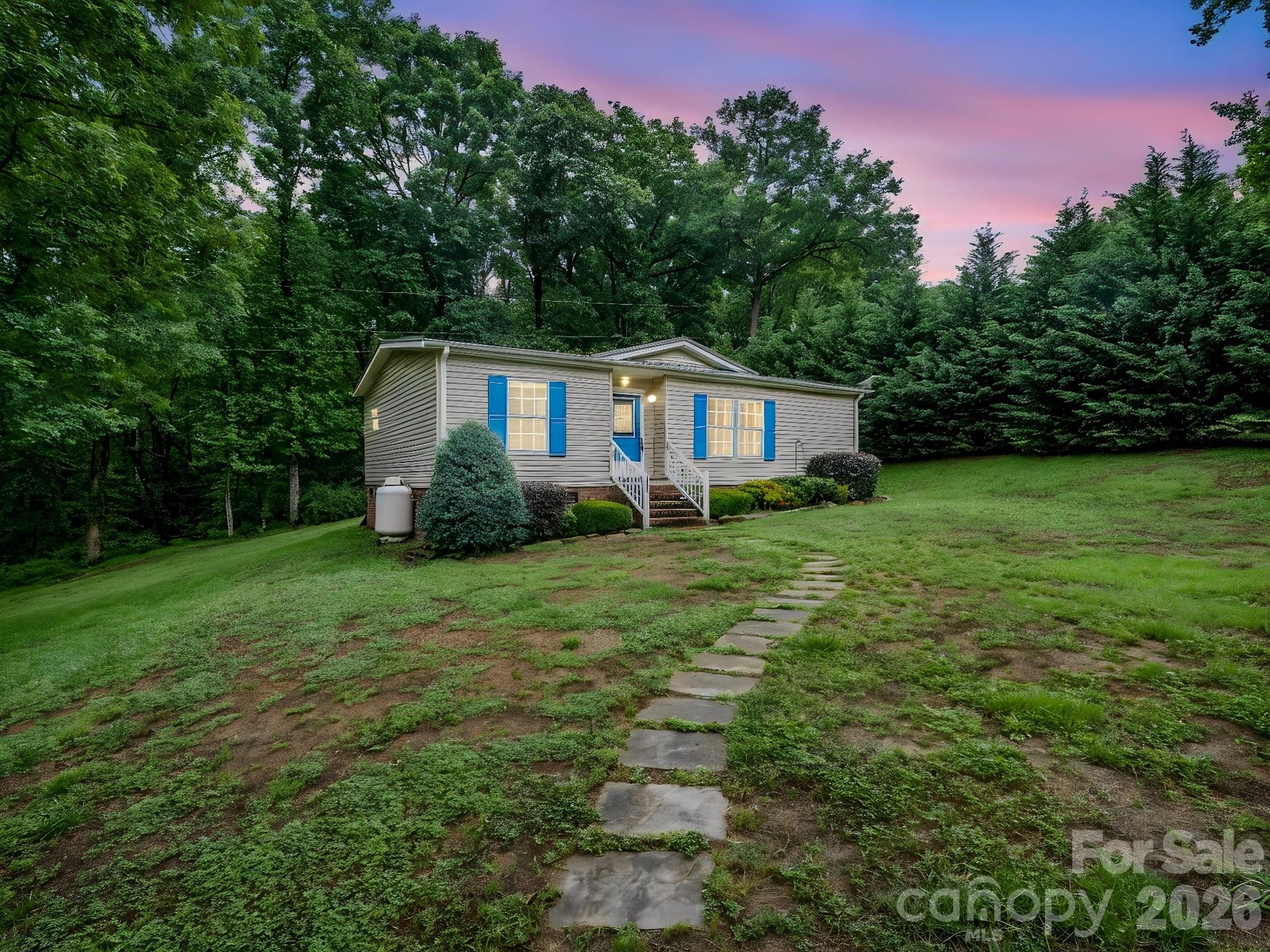 Tucked back among the trees, this charming two bedroom, two bath home sits on 1.19 acres with a peaceful setting. Enjoy your coffee or entertaining guests on the new deck with the creek nearby. The versatile shed with AC, new flooring, siding and deck is ideal for hobbies, storage, a workshop or personal retreat space. Inside features an open living and kitchen area with a private owners suite with walk-in closet and bath. The living room propane heater offers auxiliary heat in the event of an outage. The home is also wired for a generator. If you're looking for a quiet setting with room to enjoy nature, this property offers a wonderful blend of comfort and outdoor living.