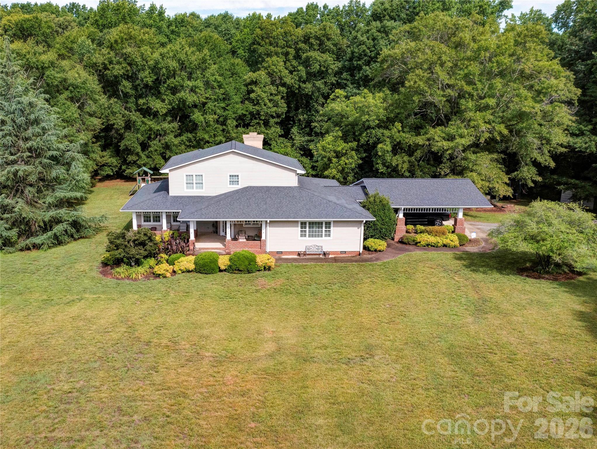 Nestled on 3 beautiful acres, this 3 bedroom, 2.5 bath home offers the perfect blend of comfort, space, and charm. The inviting covered front porch welcomes you inside to a spacious floor plan highlighted by a dramatic two-story family room featuring a floor-to-ceiling rock fireplace with gas logs as the centerpiece.
The main-level primary suite provides a private retreat with a large walk-in closet and a bath complete with a soaking tub, oversized shower, and double vanity. The well-designed layout offers both functionality and comfort for everyday living.  Upstairs, you'll find two additional bedrooms, a full bath, and a versatile loft area that overlooks the family room below, currently there is a loft bed, could easily be an ideal space for a home office, playroom, or additional living area. Step outside and enjoy the screened rear porch and patio, perfect for relaxing, entertaining, or taking in the peaceful surroundings. With room to spread out both inside and out, this property offers country living at its best while still providing convenient access to nearby amenities.