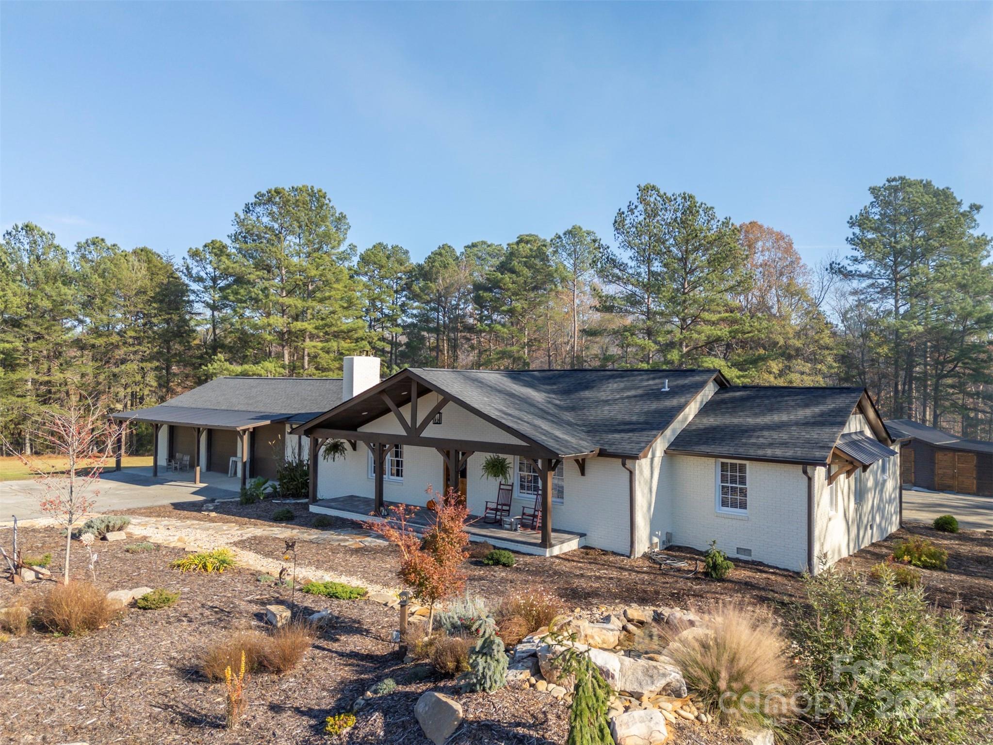 Beautiful Ranch home in Campobello nestled on nearly 7 acres of level pastureland. This stunning ranch home has been completely remodeled with exceptional attention to detail.  Rustic white oak custom cabinetry in kitchen complemented by raised ceilings and a striking large stone fireplace. Gorgeous main bathroom addition with large shower and soaker tub. Property boasts a serene water feature, a charming screened porch and deck for outdoor enjoyment. New HVAC, roof and all paint is new. It's all-new and thoughtfully customized, offering comfort, style and a picturesque setting.