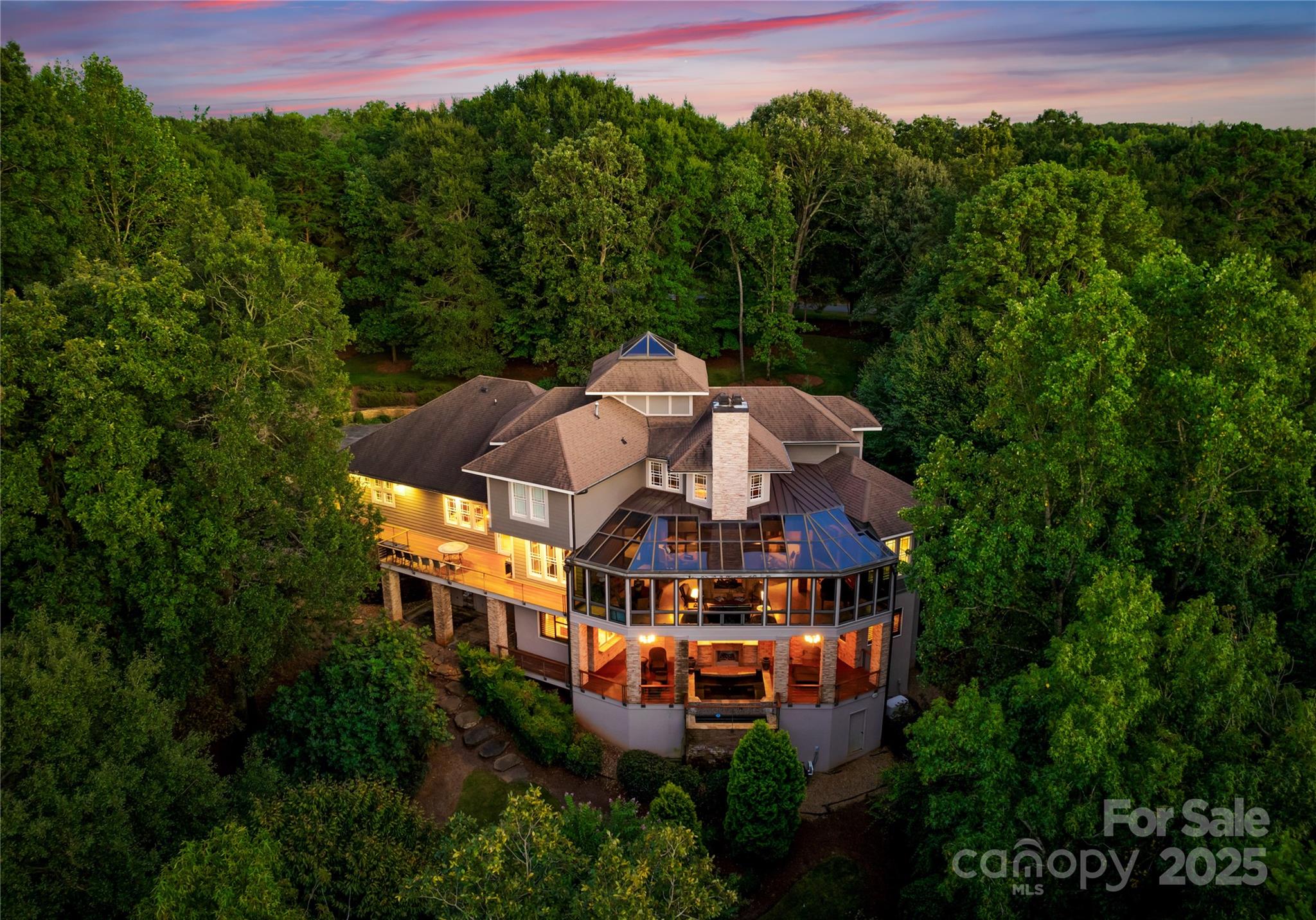 Distinguished as the “Best of Show” winner in the 2006 Homearama, this custom-built residence in The Sanctuary exemplifies architectural prestige and enduring luxury. Encompassing 7,302 square feet on 2.22 acres, the home offers an exceptional layout for both executive retreats and refined entertaining. Beyond its stately exterior, an open-concept design welcomes natural light across vaulted ceilings and sophisticated finishes. The main living area centers around a fireplace and seamlessly transitions into a chef’s kitchen appointed with Viking appliances, generous prep space, and a breakfast nook with views of the landscaped grounds. The expansive walk-out lower level is tailored for hosting on a grand scale, featuring a full bar, a spacious game and recreation room, and a climate-controlled wine cellar with capacity for 6,000 bottles. Each of the four bedrooms provides a private retreat, while the primary suite offers a spa-like bath with a soaking tub and separate shower. Outdoors, an inviting dual-sided fireplace anchors the alfresco living experience, ideal for intimate gatherings or large-scale celebrations beneath the stars. Whether hosting events or seeking a restorative personal retreat, this residence is both an entertainer’s dream and a refined sanctuary for the executive lifestyle. A four-car garage completes the offering, with ample space for automotive or recreational collections. Positioned in a highly sought-after enclave, this home offers privacy, presence, and an elevated lifestyle curated for the discerning buyer.
