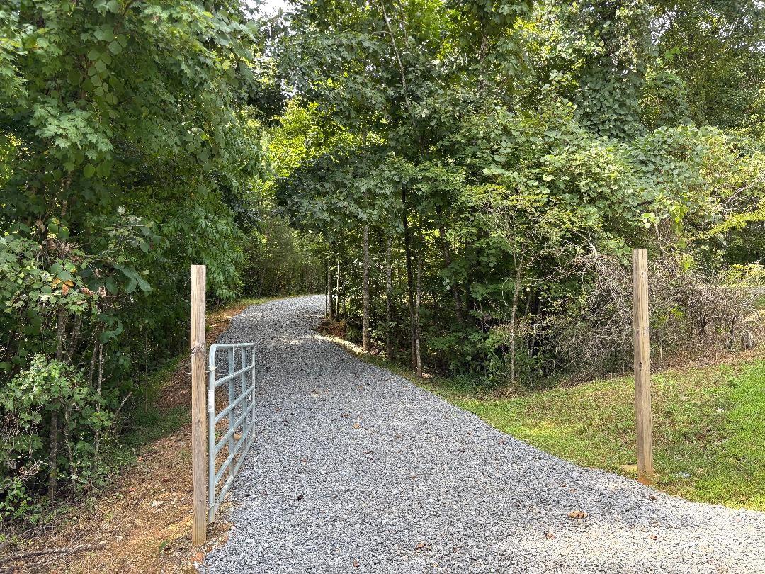 Private serenity, yet only +/- 5 miles from bustling Marion and I-40...don't miss out on this fantastic property! No HOA or fees and very minimal restrictions. Build your small getaway (840 sq ft minimum), listening to your expansive flowing creek from the front porch. There is already a well (new pump in 2025) and septic in place! New electrical has been set up with 2 RV hookups. A new shed w/electrical is also on the property. All work has been properly permitted. Come and explore the potential this 8.23 acres holds!!