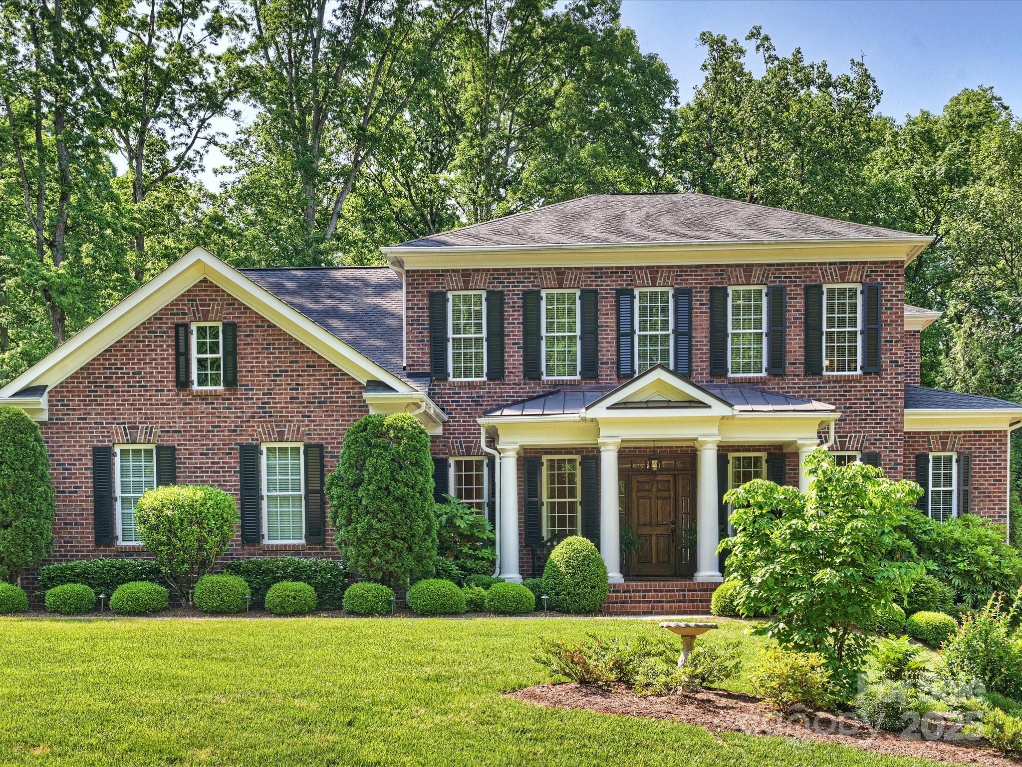 Beautifully maintained Traditional two story brick home with walkout basement, built in 2012 with over 6,000 sq feet of living space. This home has it all, from the elegant formal living and dining rooms to the open kitchen and great room which spill on to a beautiful covered deck overlooking the gorgeous backyard. Primary BR Suite on the main floor with dual walk-in closets. Upper floor has 4 BR's each with en suite baths and a bonus room. Walk-out basement includes home office, exercise room, large family/rec room with custom built-in cabinetry, wet bar complete with beverage refrigerator, sink and dishwasher.  Home has tons of storage from two walk in attic spaces on 2nd floor to the 454 sq foot storage room in basement. Doors from basement open to another covered outdoor area with built-in grill overlooking terrace with brick fireplace & access to walking trails. Attached 3-car garage. Unbeatable location in Foxcroft with 2 neighborhood swim & racquet clubs - Memberships Required.