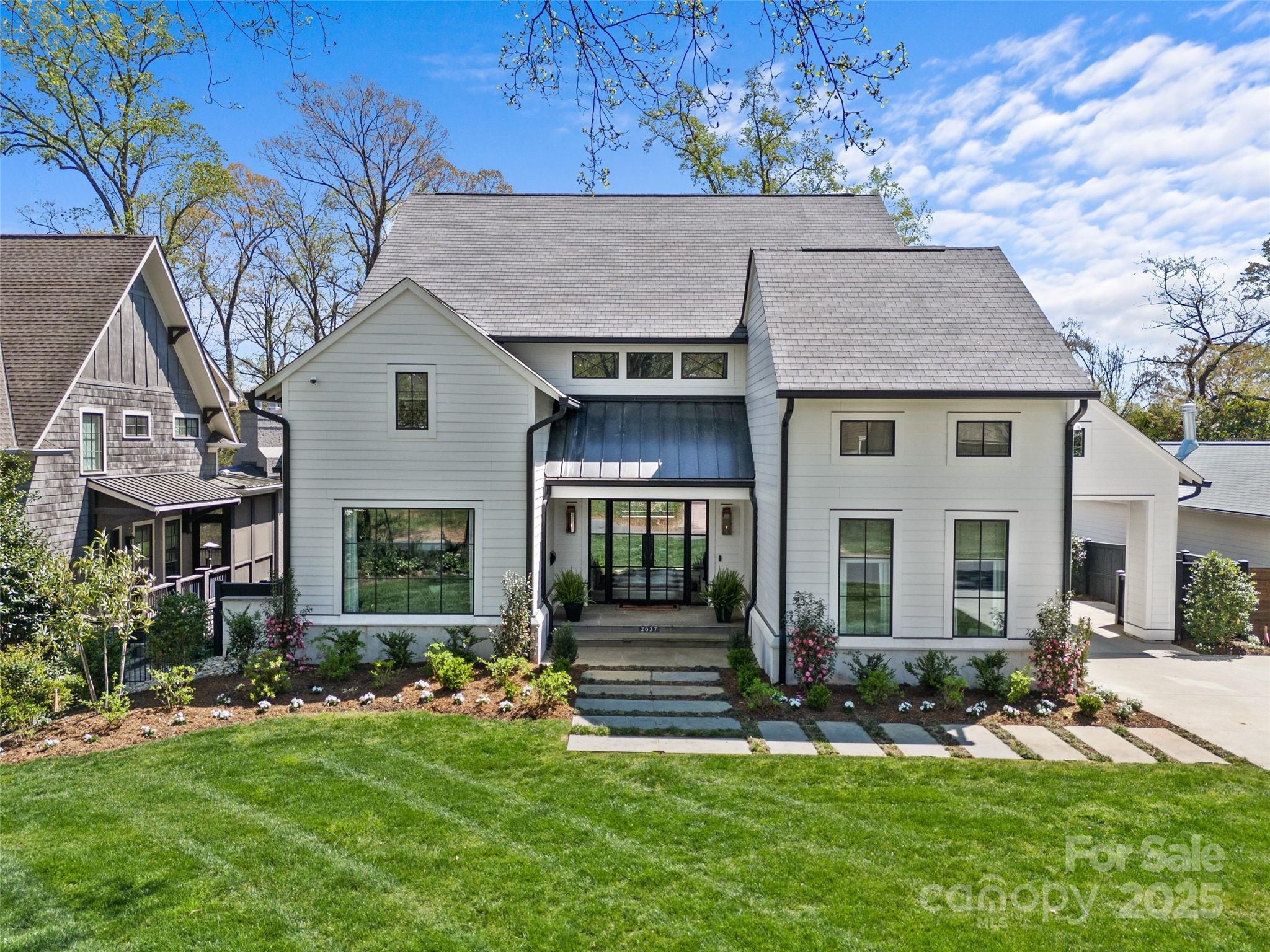 LUXURY LIVING IN MYERS PARK! This custom home exudes luxury and sophistication. Desirable floorplan for effortless entertaining and everyday living. Show-stopping chef's kitchen with island, scullery and breakfast area, open to fireside living room. Main level guest suite with ensuite bath. Beautiful dining room and study also on main. Primary and three additional bedrooms with ensuite baths and walk-in closets, upstairs along with large laundry room and built-in desks. Extend entertaining in basement featuring rec area and flex room or outdoors on the covered back porch overlooking the beautiful backyard. Detached two-car garage. Convenient to shops and restaurants in Myers Park area and easy commute to Uptown.