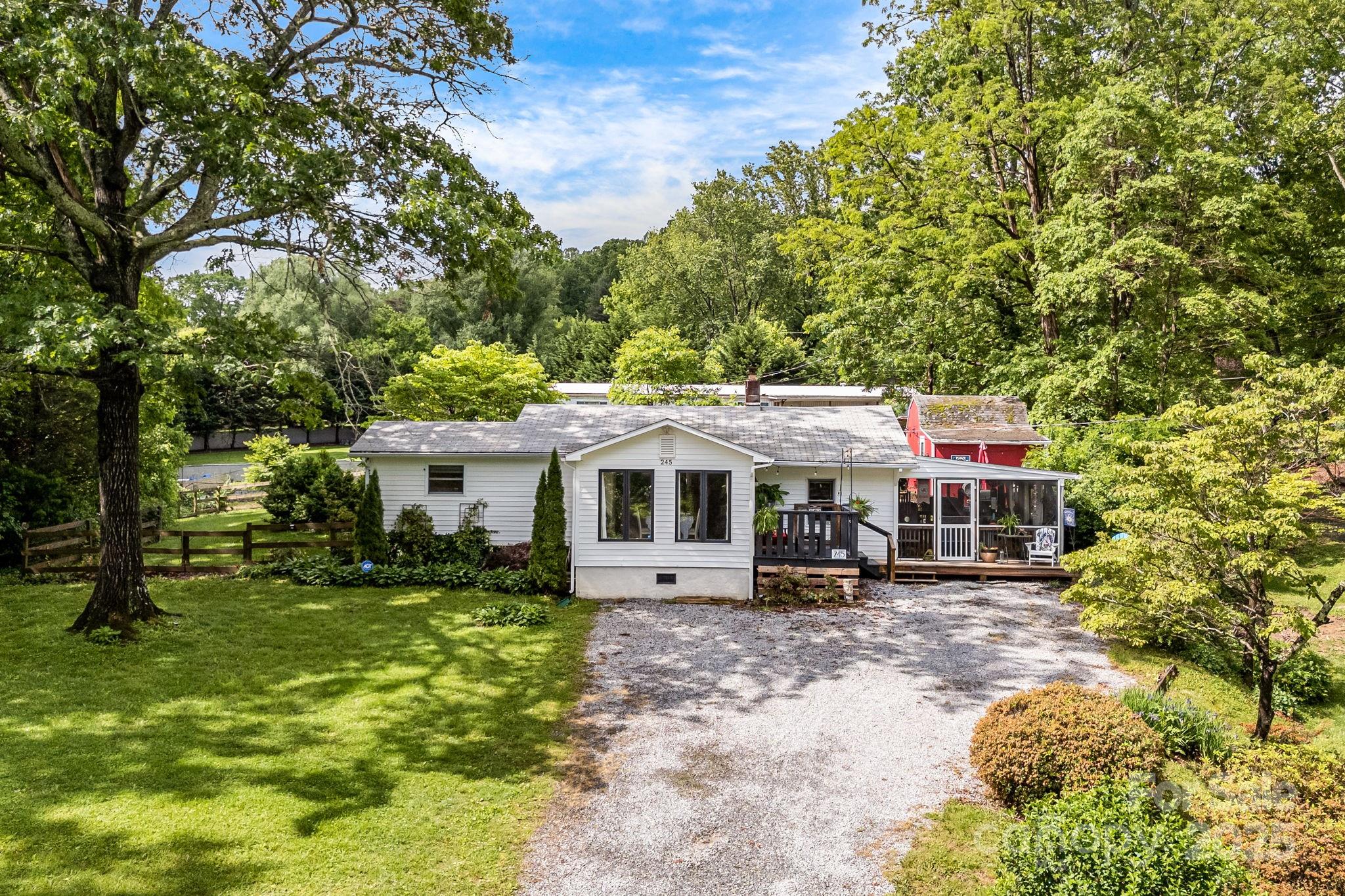A charming & pre-inspected 3 bedroom/2 full bath home in the sought after Druid Hills neighborhood in Hendersonville - this home exudes character! Situated on a nice sized lot with mature trees and plantings, there is a very nice and fenced back yard (ready for the pups!) with storage barn and lean-to attached. A bonus root cellar is also in the back. One of the favorite features is the large screened in porch - a great place to relax, entertain, or dine al fresco. Inside you'll find a nice living area with formal dining area with big windows for great natural light, a spacious living area and thoughtfully updated kitchen with stainless appliances, backsplash and farmhouse style sink. There is a laundry room (washer/dryer convey with home!) and access to the screened porch. All of this in a super convenient location to the amenities of Hendersonville. Make sure you see the property video here: https://listings.wncrealestatephotography.com/videos/0196d451-cfcf-734f-9f37-44e78db2f603