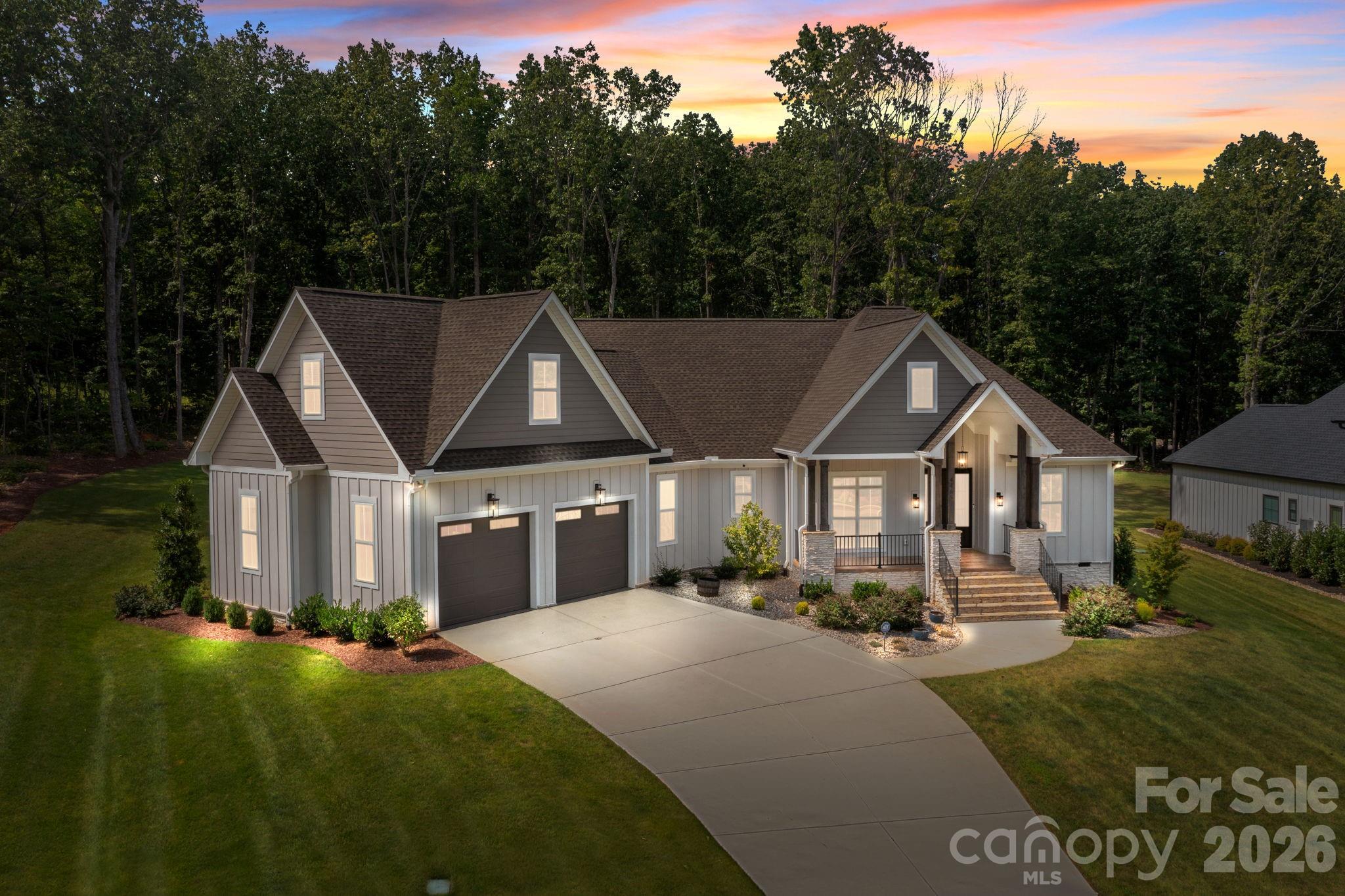 Welcome to this stunning custom-built ranch with a spacious bonus room upstairs that can easily serve as a 4th bedroom. Thoughtfully designed with high-end finishes and a flowing open-concept layout, this home offers the perfect balance of everyday functionality and luxurious living. From the moment you arrive, you'll be captivated by the curb appeal with beamed columns, stone accents and a charming front porch welcome you through elegant double doors into a beautifully crafted interior. Just off the foyer, a formal dining room features a bold accent wall, setting the tone for the style and quality found throughout. The heart of the home is the vaulted family room, where wood accents, a center beam, and a brick fireplace with custom built-ins create a cozy and inviting space. A full wall of glass with sliding doors leads to the incredible Eze-Breeze all-seasons porch seamlessly blending indoor and outdoor living. The chef’s kitchen is a true showstopper, complete with a massive center island with farmhouse sink, gas range under a custom alcove, and stylish shelving flanking the cooking space. Don’t miss the hidden walk-in pantry discreetly located beside the refrigerator! A split-bedroom layout provides privacy for all. Two generous secondary bedrooms share a unique wet area design, each with its own sink and walk-in closet. The private primary suite is a true retreat—double wood doors open to a spa-inspired bath with soaking tub, oversized tiled shower, dual vanities, and luxurious finishes. Additional highlights include a large laundry room with sink and folding counter, a pocket office ideal for remote work, and a versatile upstairs bonus room perfect as a 4th bedroom, guest suite, or media room. Set on nearly 1.4 acres of manicured lawn backing to woods, the outdoor living is just as impressive—relax or entertain on the custom patio and enjoy the peace and privacy of your own backyard sanctuary. This home truly has it all—style, space, and serenity. Come experience it for yourself! Nearly 200k in upgrades since the home was purchased including: hardscape, sod, irrigation, yard drainage, LeafGuard, Eze Breeze porch, garage epoxy plus built-in storage; hardwired speakers, tvs & thermostats; whole house water filtration; bonus room built-in bench; and the list goes on!!