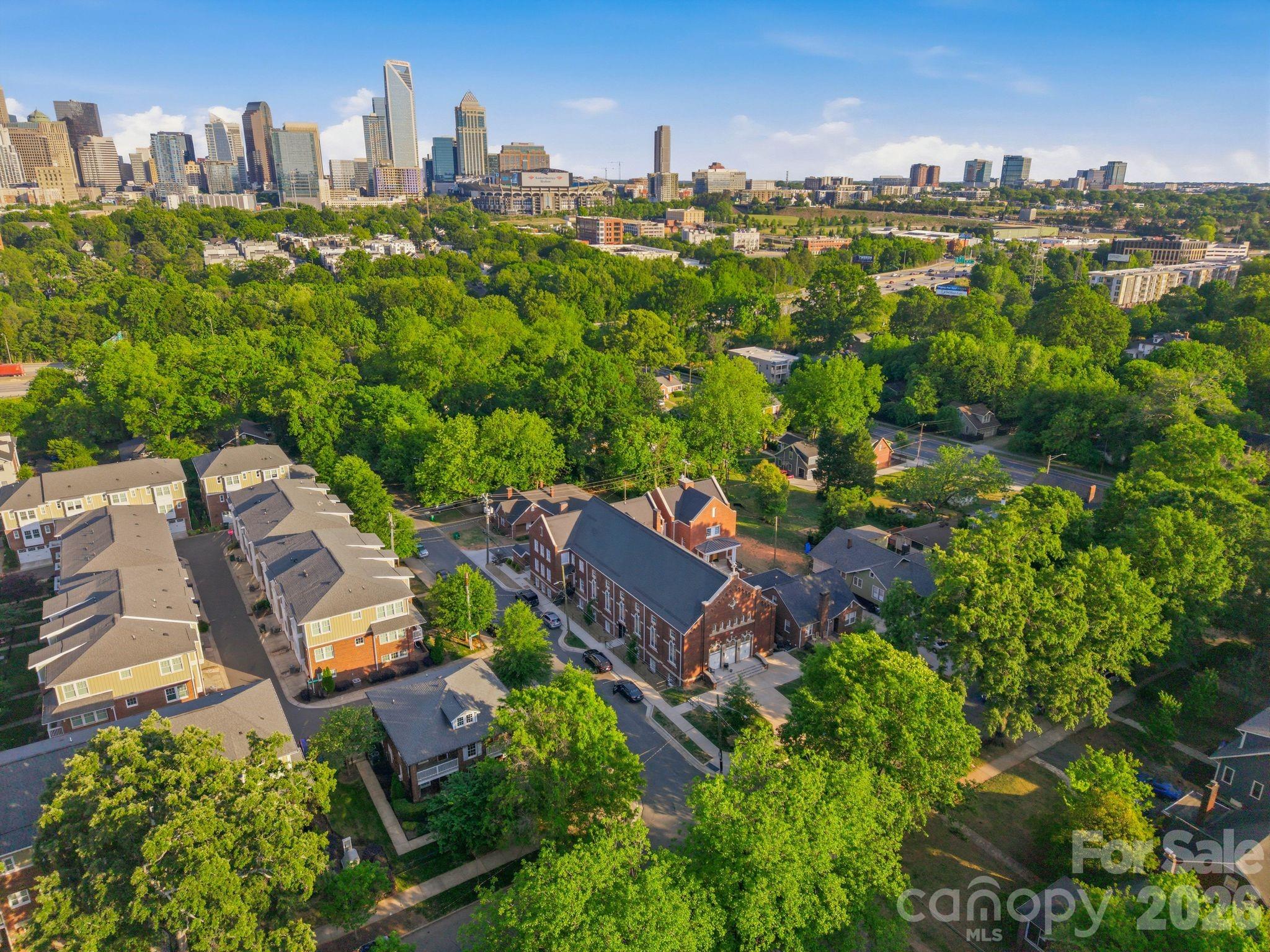 A rare opportunity to own newly constructed luxury living within one of Charlotte's most distinctive adaptive reuse communities. Located within The Arches in the heart of Wesley Heights, this 3-story townhome-style condo blends modern design with the architectural presence and history of the neighboring restored 1920 church. Built in 2023 as part of the community's thoughtfully integrated expansion, this residence offers 2 bedrooms, 2.5 baths, approximately 1,337 square feet, and a private rooftop terrace designed for elevated urban living.

The open-concept main level features abundant natural light, a spacious living area, and a modern kitchen complete with quartz countertops, stainless steel appliances, custom cabinetry, tile backsplash, and a large island ideal for both everyday living and entertaining. Upstairs, both bedrooms offer privacy and functionality with well-appointed baths and clean, modern finishes throughout. The rooftop terrace provides an additional outdoor living space perfect for relaxing, entertaining, or enjoying skyline views and evening sunsets.