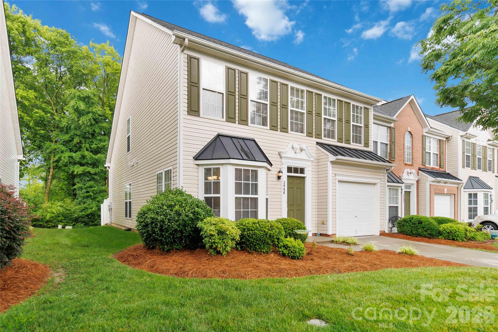 Welcome to this beautifully maintained end-unit townhome in sought-after Harris Town Center. Offering an open and inviting floor plan, this spacious home features a large primary suite on the main level complete with a tray ceiling, walk-in closet, ensuite bath, with walk-in shower and in-ceiling speakers. The dramatic two-story great room with vaulted ceiling and in-wall speakers flows seamlessly into the dining area and overlooks the kitchen while creating an ideal space for both everyday living and entertaining. Fresh paint in many areas and brand-new carpet throughout provide a clean, updated feel ready for its next owner.

The kitchen offers tile flooring, pantry, and a bright breakfast area surrounded by windows that fill the space with natural light. Upstairs, you’ll find a large loft overlooking the great room along with two generously sized bedrooms, each featuring oversized walk-in closets, bathroom and a huge walk-in attic space great for storage. Additional highlights include a conveniently located first-floor powder room, one-car garage, and a private rear patio with partial fencing and mature greenery for added privacy.

Residents enjoy low-maintenance living with HOA dues covering water, sewer, trash service, yard maintenance, community pool. Excellent location close to shopping, dining, and everyday conveniences.