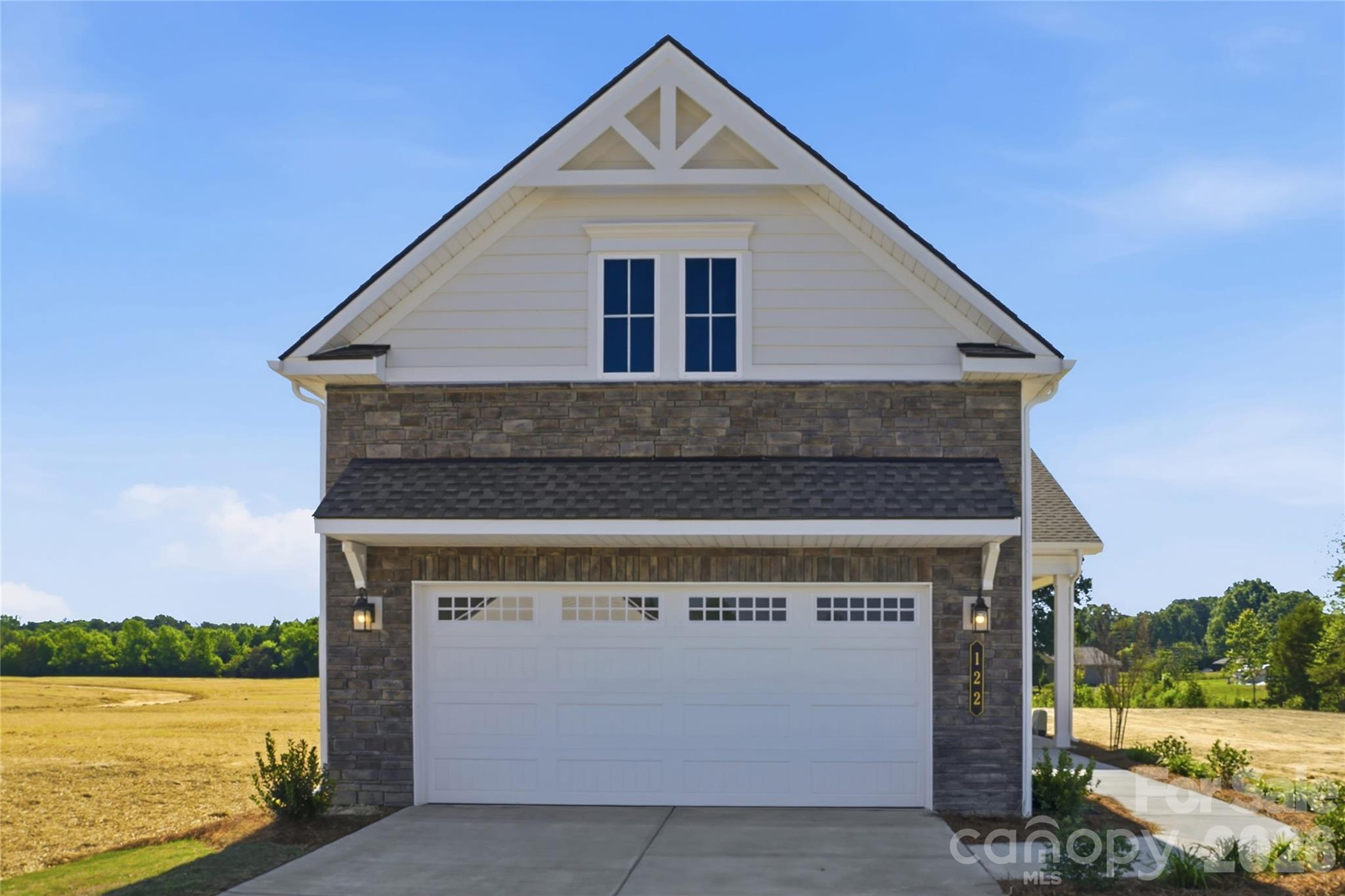 **Move-In Ready** Located in the gated 55+ community of Cresswind at Rocky River, this move-in ready Caroline floorplan offers 3 bedrooms, 2 bathrooms, a sunroom, and an extended 2-car garage within a thoughtfully designed single-story layout. The home features an expanded owner’s suite, separate dual walk-in closets, revised laundry room layout, and a spacious open-concept living area centered around a linear fireplace with tile surround and mantel detail.
The kitchen includes quartz countertops, upgraded cabinetry, crown molding, tile backsplash, under-cabinet lighting, pendant lighting, and a GE appliance package with a gas slide-in range, microwave, dishwasher, and single-bowl undermount sink. EVP flooring runs throughout the main living spaces, owner’s suite, foyer, laundry room, and sunroom for a cohesive look throughout the home.
The extended sunroom adds additional living and entertaining space while connecting to the uncovered rear patio. The owner’s suite includes additional windows, dual walk-in closets, and a spa-inspired bath with a frameless glass shower enclosure, floor-to-ceiling shower tile, quartz countertops, ceiling-height mirrors, and upgraded fixtures and lighting.
Additional highlights include attic storage with pull-down access, a laundry room with cabinetry, countertop, and utility sink, structured wiring upgrades, upgraded lighting throughout the home, and ceiling fans in the great room, owner’s suite, and sunroom.