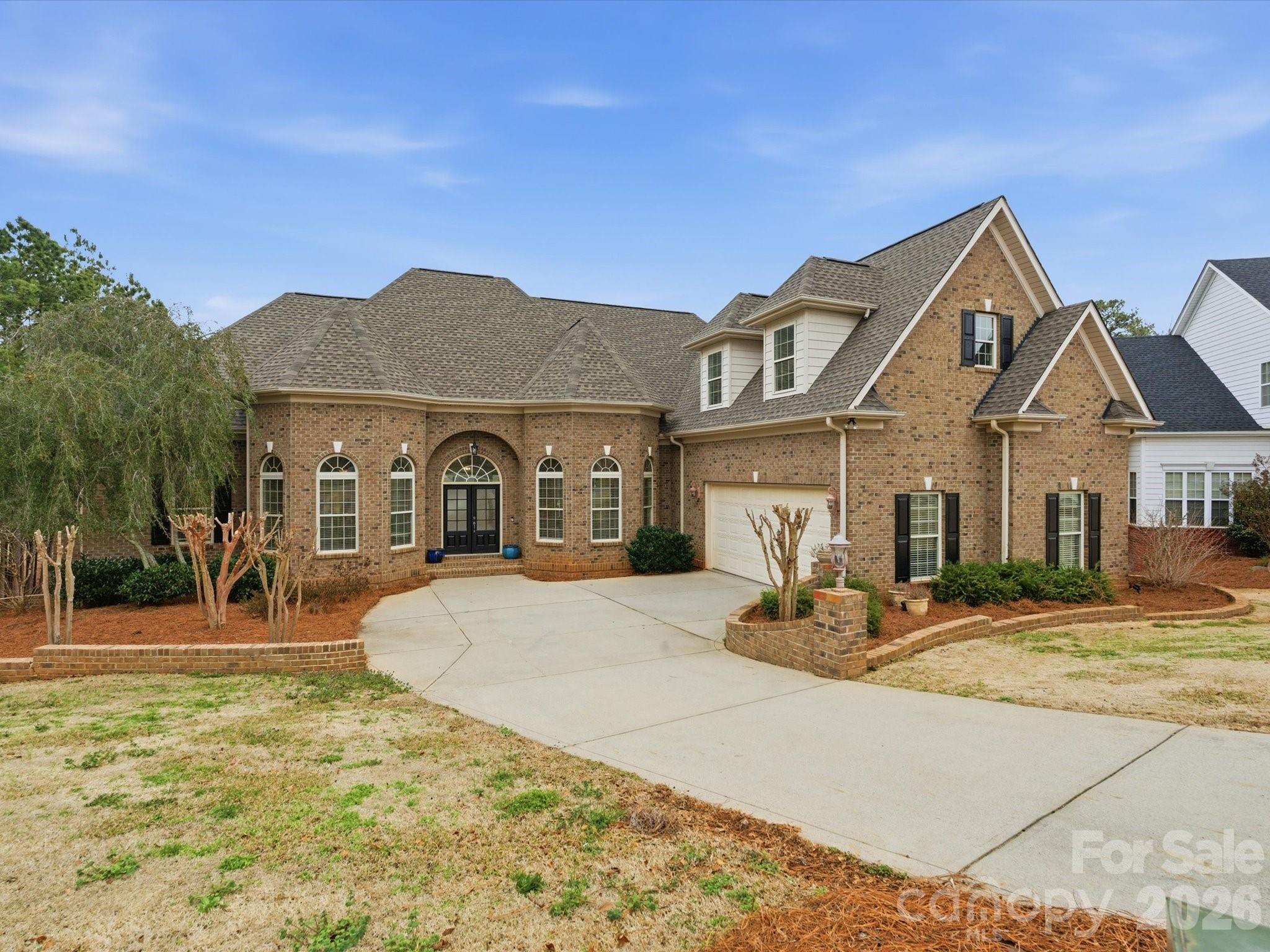 Enjoy sweeping views of the 11th hole at Waterford Golf Club and a tranquil pond from this custom-built French Country estate by Haines Maxwell, ideally tucked away on a quiet cul-de-sac in the prestigious Waterford Glen community. Fresh paint throughout the entire main floor enhances the light-filled interior. Coffered ceilings accent the great room, and the gourmet kitchen showcases dual sink prep areas, custom cabinetry, and high-end stainless appliances including a gas range. This home features a desirable split-bedroom layout, with each bedroom offering a private bath and two walk-in closets. The spacious primary suite offers private deck access, dual vanities, walk-in shower, and two walk-in closets. The expansive back porch captures sweeping golf course and water views perfect for relaxing or entertaining, while the yard’s in-ground irrigation system keeps the landscape lush and beautifully maintained year-round. The expansive back porch captures sweeping golf course and water views—perfect for relaxing or entertaining, while the yard’s in-ground irrigation system keeps the landscape lush and beautifully maintained year-round.. The lower level includes two bedroom suites, a workshop, and unfinished space plumbed for a future bar and wine cellar. An unfinished bonus area over the garage is also plumbed for a full bath, ideal for a fifth bedroom or flex space. Recent updates include a new roof (2023), new plumbing (2023), rebuilt deck (2022), and a first-floor HVAC system less than two years old, plus a tankless water heater. Seller will share original architectural plans if desired. Patio furniture can remain at buyer’s request.