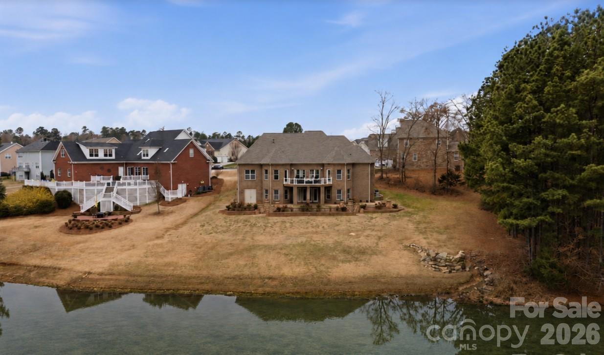 Enjoy sweeping views of the 11th hole at Waterford Golf Club and a tranquil pond from this custom-built French Country estate by Haines Maxwell, ideally tucked away on a quiet cul-de-sac in the prestigious Waterford Glen community. Fresh paint throughout the entire main floor enhances the light-filled interior. Coffered ceilings accent the great room, and the gourmet kitchen showcases dual sink prep areas, custom cabinetry, and high-end stainless appliances including a gas range. This home features a desirable split-bedroom layout, with each bedroom offering a private bath and two walk-in closets. The spacious primary suite offers private deck access, dual vanities, walk-in shower, and two walk-in closets. The expansive back porch captures sweeping golf course and water views perfect for relaxing or entertaining, while the yard’s in-ground irrigation system keeps the landscape lush and beautifully maintained year-round. The expansive back porch captures sweeping golf course and water views—perfect for relaxing or entertaining, while the yard’s in-ground irrigation system keeps the landscape lush and beautifully maintained year-round.. The lower level includes two bedroom suites, a workshop, and unfinished space plumbed for a future bar and wine cellar. An unfinished bonus area over the garage is also plumbed for a full bath, ideal for a fifth bedroom or flex space. Recent updates include a new roof (2023), new plumbing (2023), rebuilt deck (2022), and a first-floor HVAC system less than two years old, plus a tankless water heater. Seller will share original architectural plans if desired. Patio furniture can remain at buyer’s request.