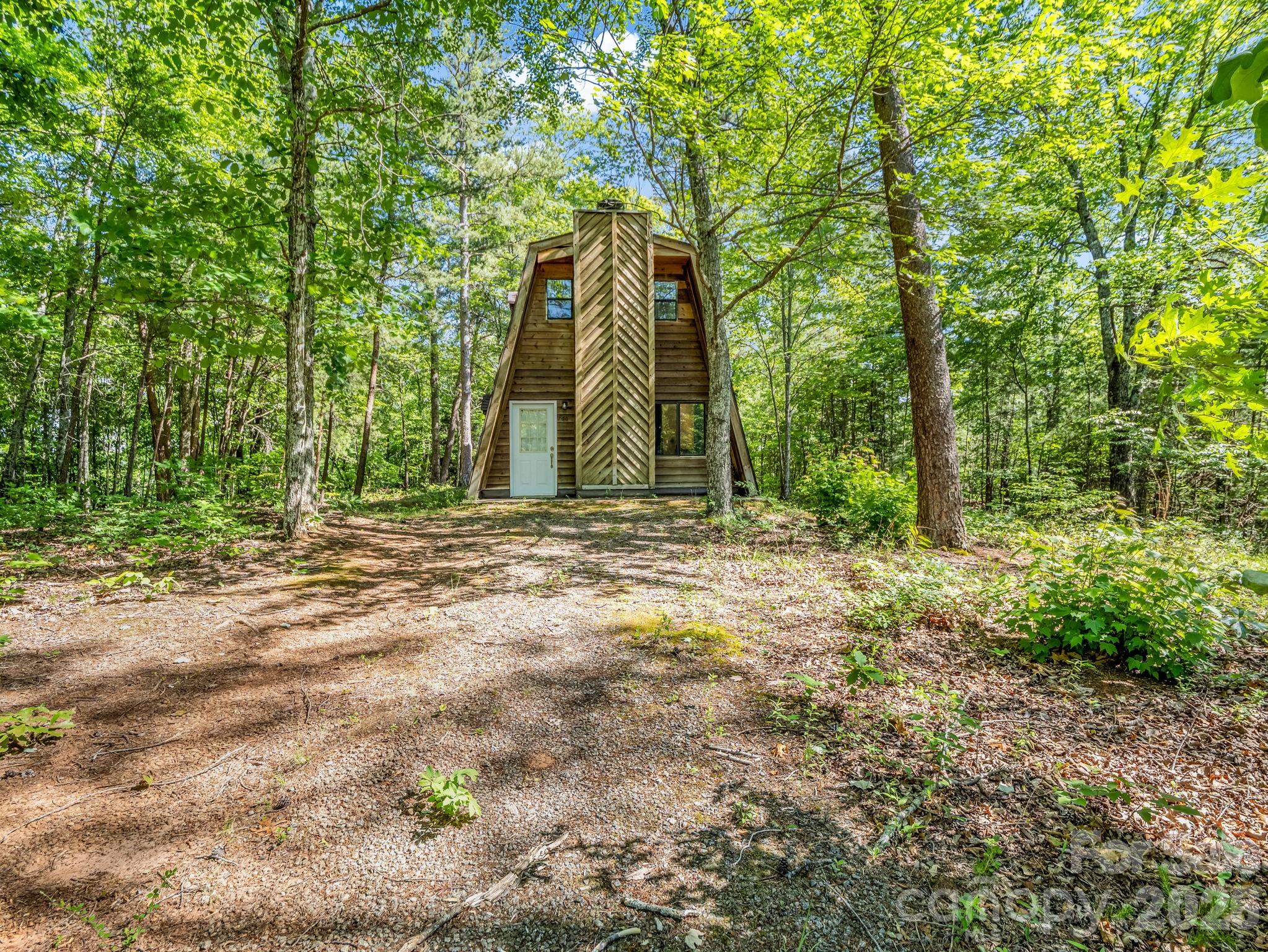 Perched atop scenic Justice Drive, this charming and truly original Lake Lure property offers the perfect blend of mountain privacy and accessibility. Set on a peaceful paved circular cul-de-sac drive, “Blue Heaven” captures stunning long-range winter mountain views and a serene wooded setting just minutes from the beauty and recreation of Lake Lure.

This unique modified A-frame sits on a beautifully usable 1.22-acre parcel with plenty of parking, exceptional character, and an inviting mountain feel throughout. Enjoy easy access to Black Mountain, Hendersonville, and Asheville while embracing the peaceful lifestyle of the Western North Carolina mountains. Whether you’re looking for a full-time residence, mountain getaway, or investment opportunity, this one-of-a-kind property delivers charm, privacy, paved access, and unforgettable views in one of the region’s most scenic locations.