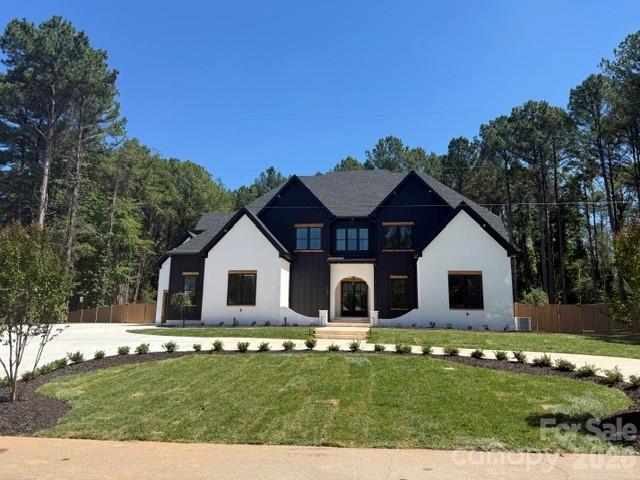 New construction on a level 1-acre lot with Lake Norman water views, just past The Point and with no HOA! Circular drive, extended driveway, and a 3-car garage with wood doors and epoxy flooring. No detail was overlooked—white oak floors, designer lighting, and a gourmet kitchen featuring custom cabinetry, waterfall-edge island, matching backsplash, Wolf range, wall oven, microwave, and Sub-Zero refrigerator. Scullery with secondary refrigerator, prep sink, and wine fridge. Open floor plan with a modern fireplace and main-level primary suite. Spa-like bath with a soaking tub and stunning walk-through shower. Custom closet shelving with gold accents and direct access to the laundry room. Upstairs offers a second laundry room, 4 bedrooms, 4 baths, and a vaulted media room. Abundant storage throughout, plus low-voltage wiring and built-in speakers. Private fenced backyard with outdoor fireplace, built-in grill, saltwater pool, tanning ledge, and hot tub. Professionally landscaped with sod and irrigation. A true showstopper!