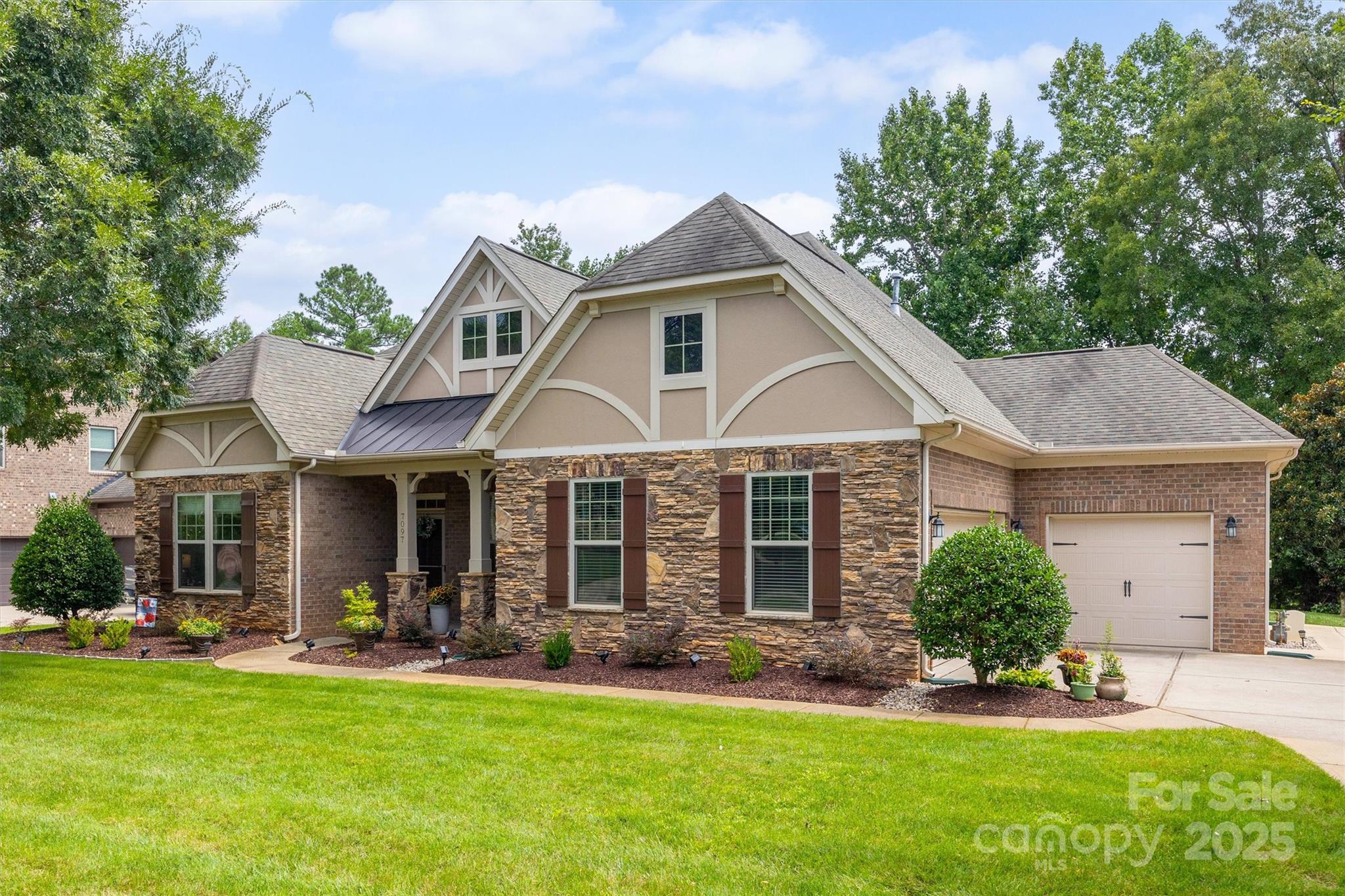 From the moment you pull up, this brick and stone beauty feels like home. Sitting on a spacious .3-acre lot with a three-car garage, the curb appeal is undeniable—but it’s the welcoming arches, volume ceilings, and easy flow inside that truly set the tone.
Designed with mostly one-level living in mind, the home feels open, light-filled, and effortlessly comfortable. The heart of the home is the kitchen—a place where everyone naturally gathers. A large island anchors the space, surrounded by freshly painted cabinets, granite countertops, stainless steel appliances, a walk-in pantry, and a beautiful herringbone subway tile backsplash. It opens seamlessly to the dining area and great room, where newly added hardwood floors and updated light fixtures create a warm, modern feel that’s perfect for everyday living or hosting friends.
Just off the living area, step onto the screened-in porch and take in the peaceful view of trees behind the home—your own private retreat. Two outdoor patios offer plenty of space for grilling & dining. 
The main level offers thoughtful flexibility with a front flex space, two generously sized secondary bedrooms, and a spacious primary suite w/ trey ceiling is tucked away for privacy. The primary bath feels like a spa escape with dual sinks, a tiled shower, soaking tub, and a large walk-in closet. If you work from home, you’ll appreciate the private office quietly positioned at the back of the house. A convenient mudroom off the garage keeps everything organized and clutter-free.
Upstairs, you’ll find a large bonus room with a closet, a fourth bedroom, and a full bath—ideal for guests, hobbies, or movie nights—plus walk-in attic storage for all the extras.
And the location? It checks every box. Located in sought-after Barber Rock with fabulous community amenities, you’ll enjoy South Carolina’s low taxes while being just minutes from the shopping, dining, and conveniences of Ballantyne.
This is the kind of home where life unfolds easily—and where memories are waiting to be made.
