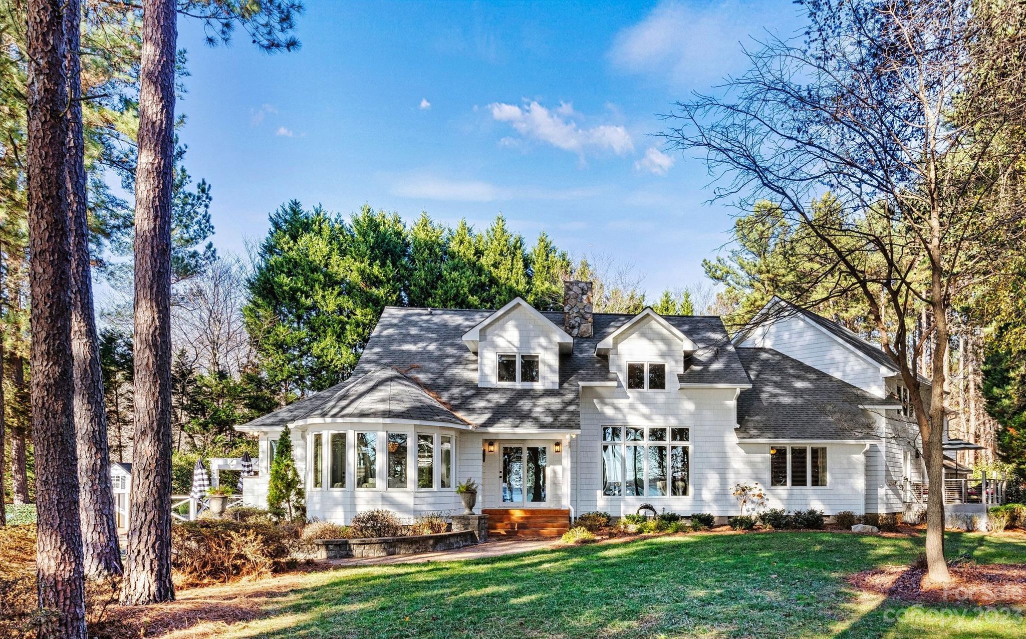 Your waterfront oasis is here! Step into the lap of luxury in this exquisite rare-find on Lake Norman. Situated on a 1.6+ acre peninsula lot just off of a main channel, you will see big water year-round. Not to mention waterfront views from almost every room in the house! Entertain in style in this freshly renovated home where timeless elegance meets daily comfort. As you enter, you are greeted by a gorgeous river rock fireplace ushering you into the living room with beautiful hardwoods, & you can watch picturesque sunsets over Lake Norman. The main level also hosts the owner's suite, outfitted for luxury with oversized walk-in closet and a spa like bathroom complete with lovely fireplace over the soaker tub. The dining room is fit for a feast, with room to seat a large gathering and also has a bay window overlooking tranquil waters. Upstairs you'll find an entertainment area, starlit ceiling, full bathroom w/ teak steam shower, & much more. Too many upgrades to list! A true must see.