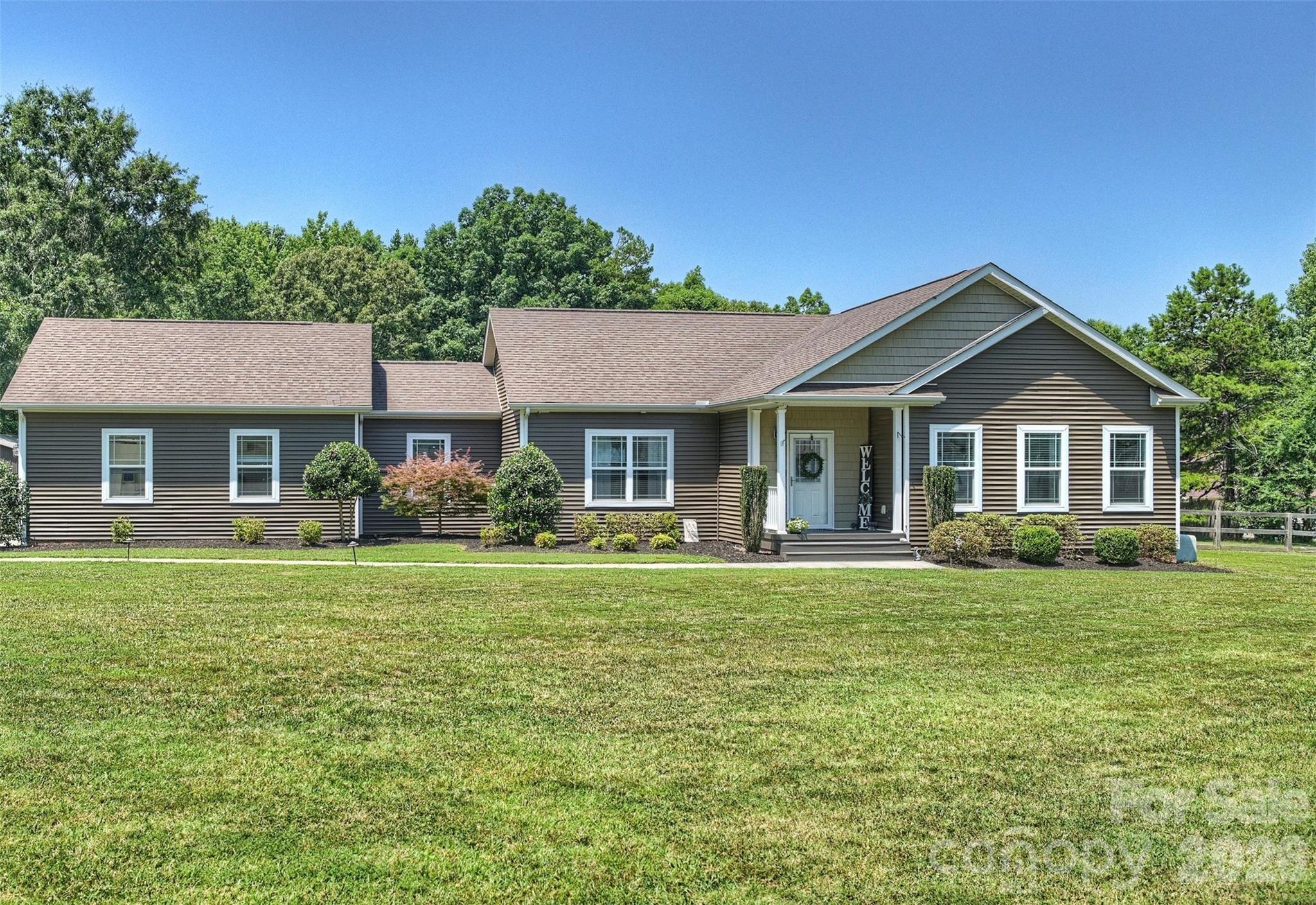 Central to Ballantyne conveniences, enjoy the freedom of country living! Situated on 2.41 private acres with no HOA and no restrictions, this beautifully maintained gem featuring 3-bedroom, 2-bath home with loads of flex space offers the perfect blend of modern comfort, open living, and outdoor space.

Built in 2019, the home welcomes you with an inviting open-concept floor plan designed for both everyday living and entertaining. The spacious living room flows seamlessly into the well-appointed kitchen featuring abundant cabinet and countertop space, stainless steel appliances, a breakfast area, and plenty of room for gathering with family and friends.

The thoughtfully designed single level ranch layout provides privacy for the primary suite, complete with a large walk-in closet, dual vanity, and an oversized walk-in shower. Two additional bedrooms and a full bath are located on the opposite side of the home, making the layout ideal for family members, guests, or a home office.

Step outside and discover the true highlight of this property. The fenced backyard offers endless possibilities—from gardening and pets to outdoor entertaining, play areas, or simply relaxing while enjoying peaceful country views. Expansive parking with both attached and a detached 20' x 20' carport offering additional parking or storage for recreational vehicles, or easy equestrian stable conversion among other hobby accommodations.

Despite its private setting, you're just minutes from the shopping, dining, and entertainment of Ballantyne, Indian Land, Fort Mill, Waxhaw, and South Charlotte, with convenient access to major highways, top employers, and everyday amenities.

If you've been searching for acreage, privacy, and the freedom to live life on your terms, this exceptional property is one you won't want to miss. Schedule your private showing today!