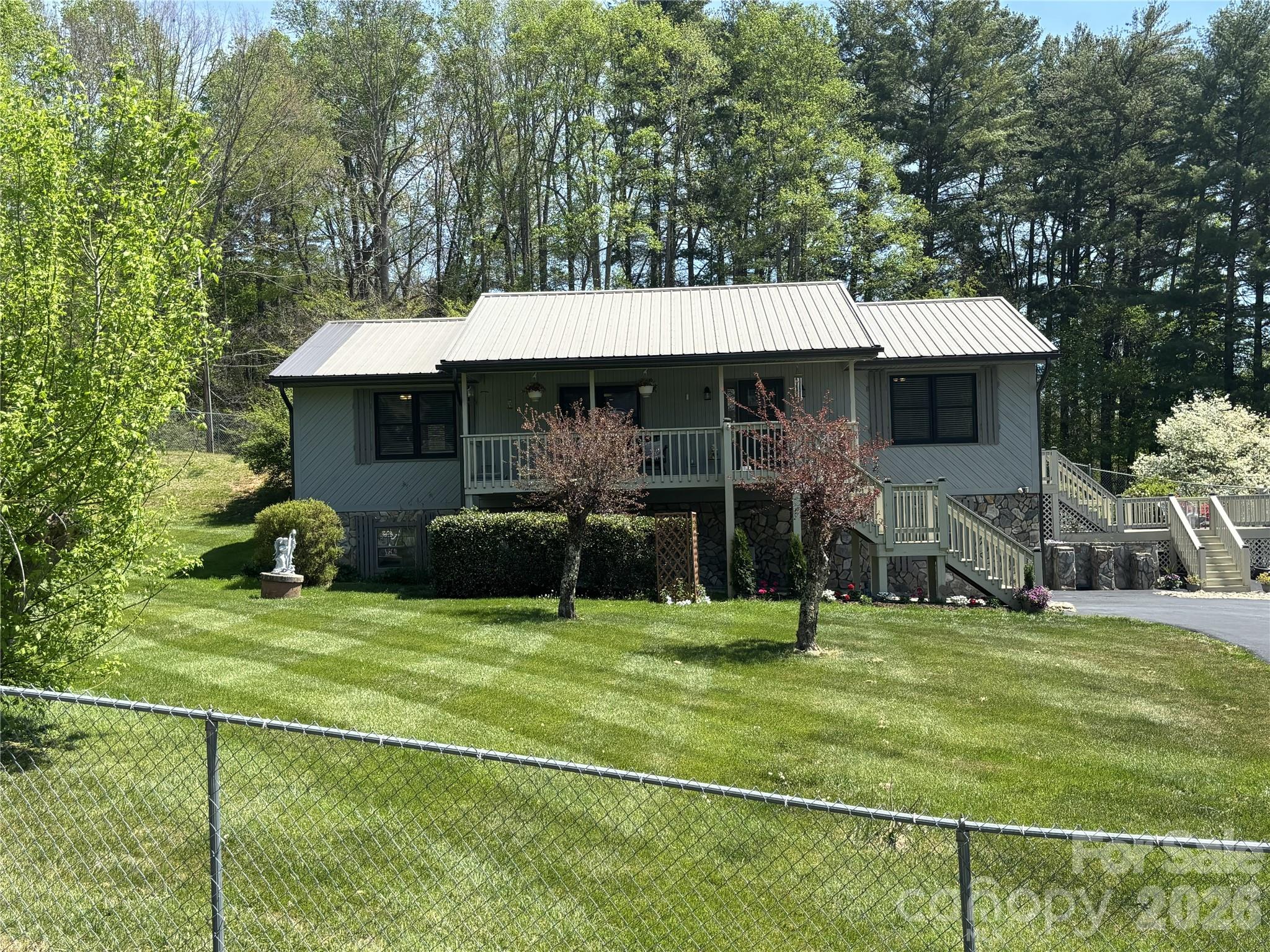 IMPECCABLE HOME in highly desirable town of Burnsville, NC.  THIS PROPERTY WAS NOT AFFECTED BY HURRICANE HELENE IN ANY WAY.  Enter by Front Porch or thru Garage.  Never worry about too many stairs to climb as this meticulous home has a Full Sized Polluck Lift Elevator in the basement & opens up to the Living Room area.  Enjoy Open Concept living in this Turn-Key home.  Kitchen features Cherry wood cabinets, Granite countertops & Stainless Steel appliances.  Family Room is cozy & inviting with knotty pine walls, cathedral ceiling & electric Fireplace.  Mountain views can be seen from Front Porch & every window, including views of Mt. Mitchell from the back Deck.  UPGRADES INCLUDE:  All new windows throughout, Full Sized Elevator, Wood flooring, entire Kitchen, both Bathrooms, Interior/Exterior doors, 4 Ton Heat Pump, Washer/Dryer, Crown molding, fresh paint Interior/Exterior, window Treatments, new lighting Fixtures & Fans, automatic Garage Door, new Gutters,  remodeled Gazebo, Asphalt driveway & electric Gate, all new electrical wiring & plumbing thru-out home.
This Raised Ranch home is situated just a few minutes from Town for easy access to shopping, eclectic eats, unique boutiques, arts & crafts, horseback riding on a 20 mile trail, fly fishing & hiking to the Roaring Fork Falls.  Visit the Dark Sky Observatory for a memorable experience, along with golfing at the Mt. Mitchell Golf Club.  Enjoy small town charm & fresh mountain air at this gateway to Mt. Mitchell.  Town offers seasonal festivals to enjoy local foods, music, local Artisans & Galleries.  Book a Showing of this fantastic home today, you will NOT be disappointed.